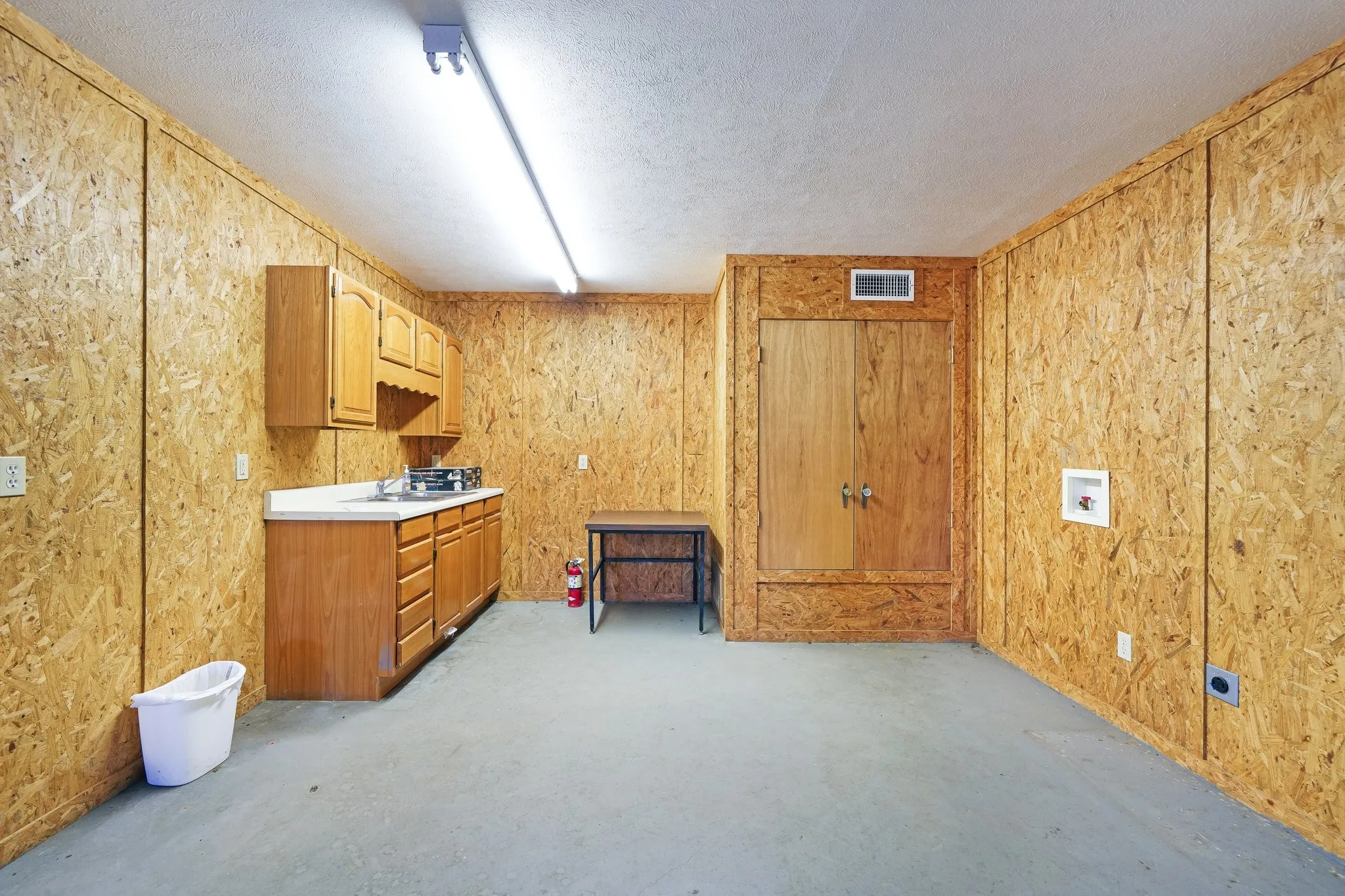 Kitchen featuring a textured ceiling and sink