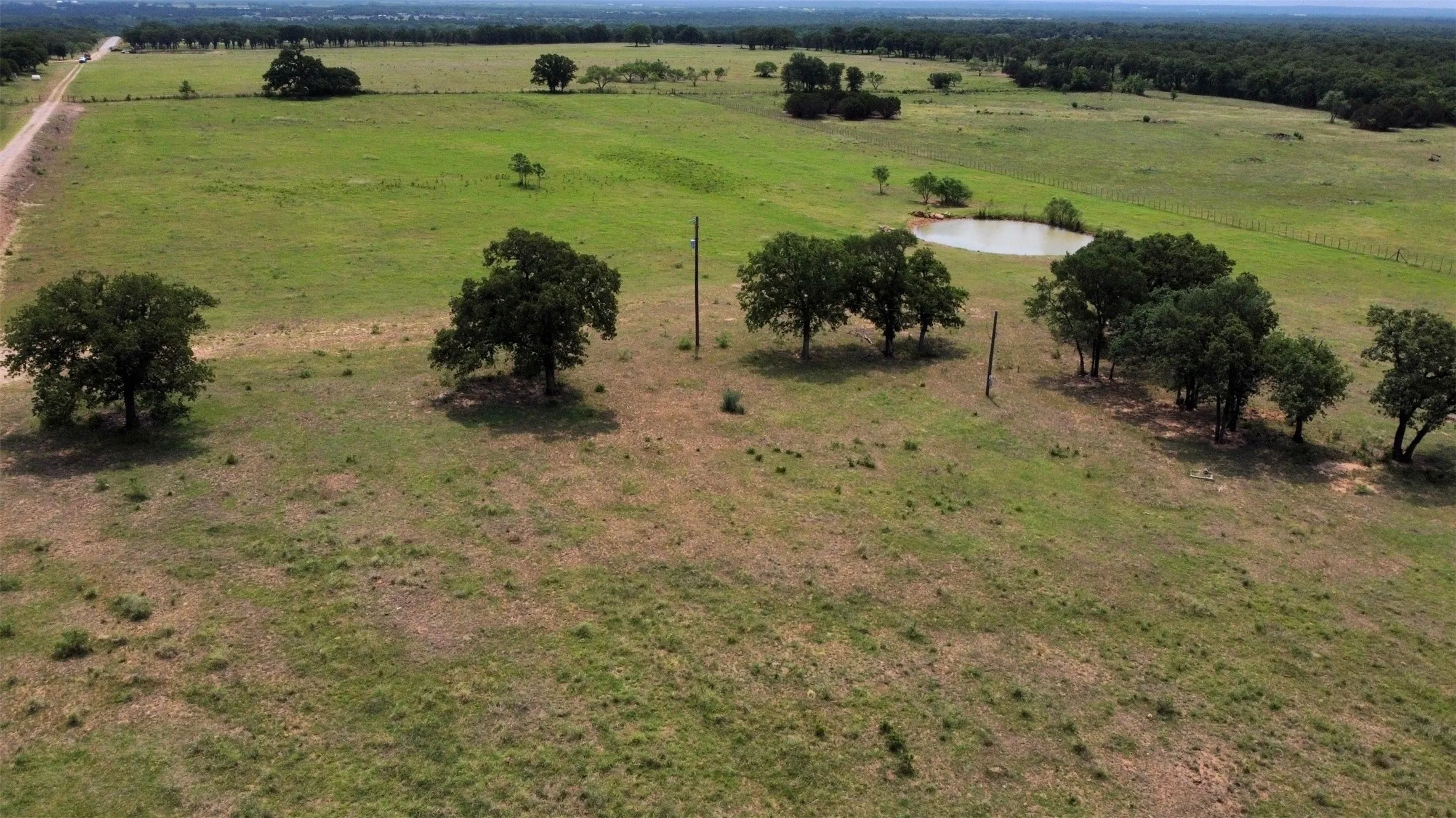 Birds eye view of property featuring a water view and a rural view