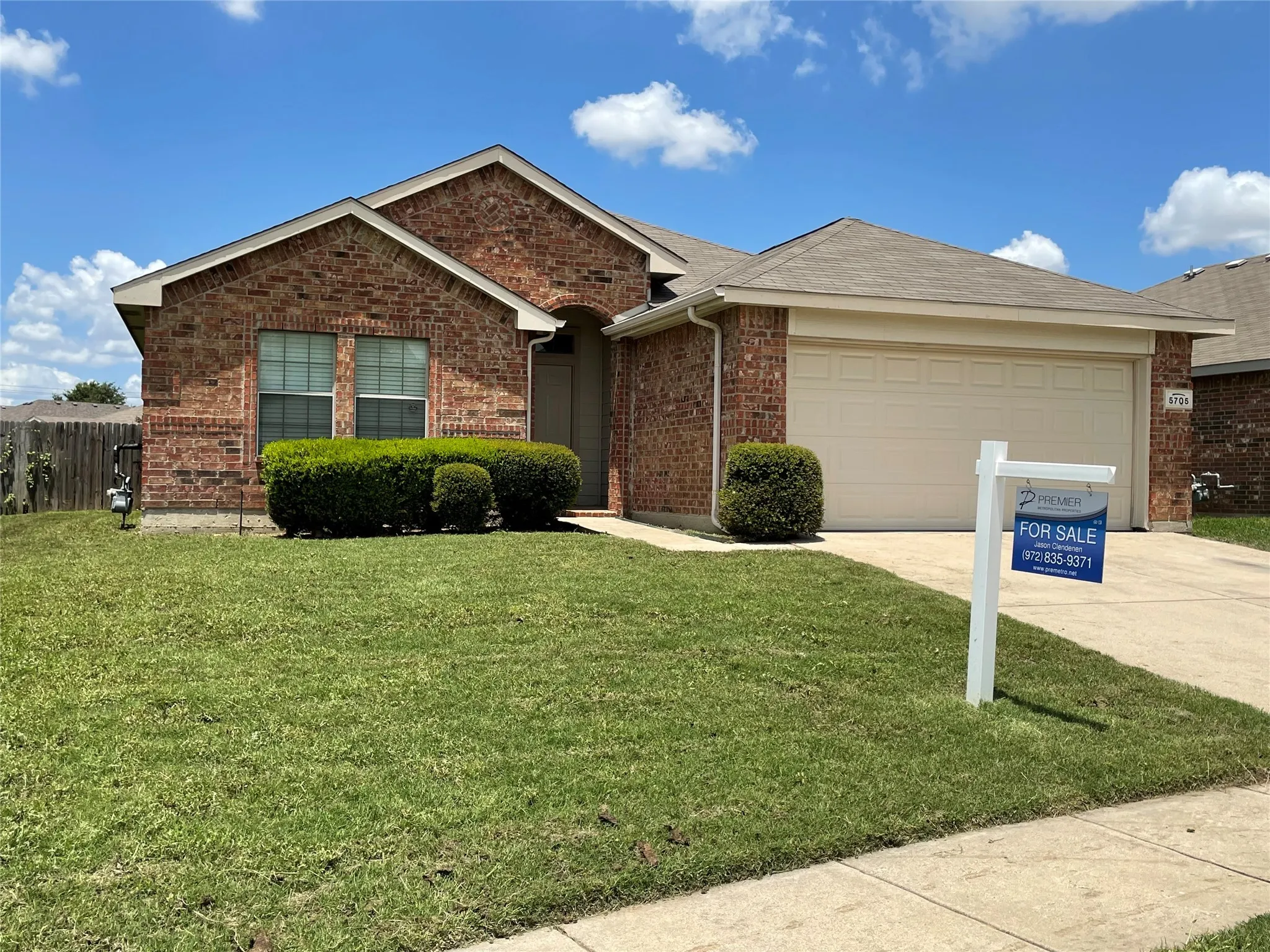 Single story home featuring a front yard and a garage