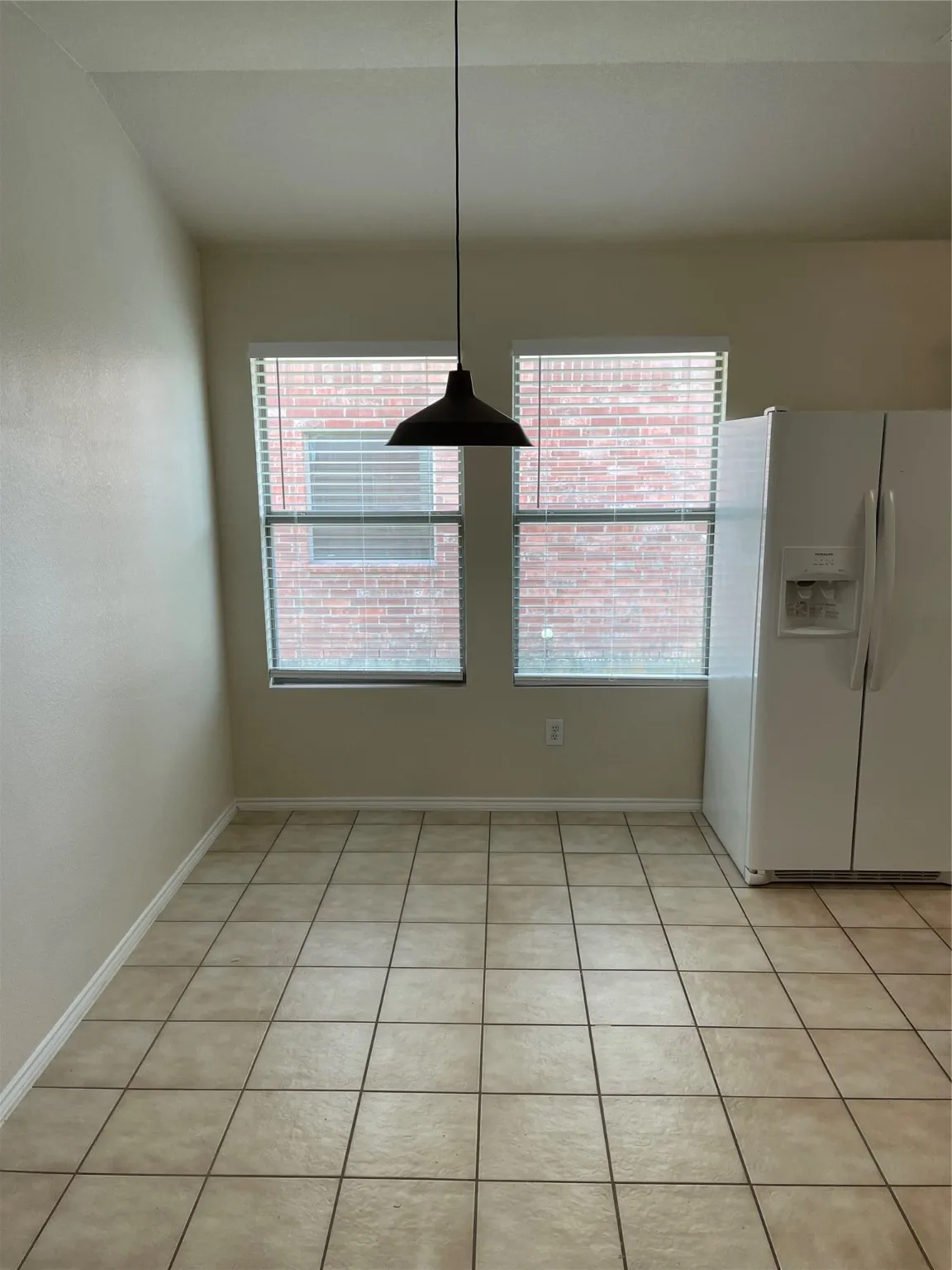Unfurnished dining area with light tile patterned floors and plenty of natural light
