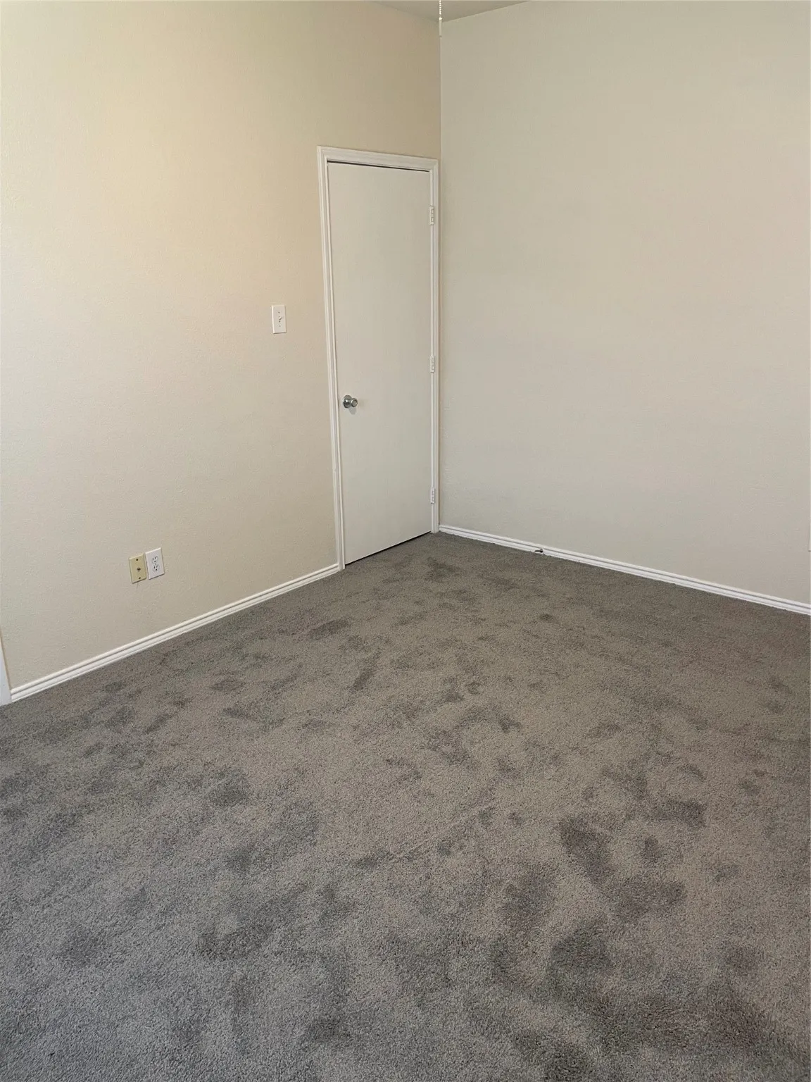 Spare room with dark carpet