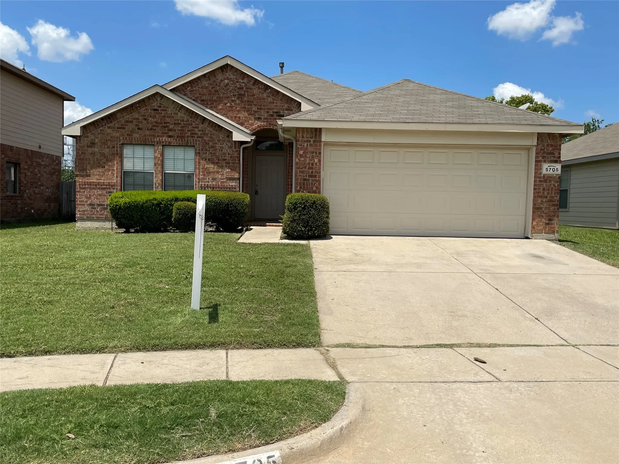 View of front of property with a front lawn and a garage