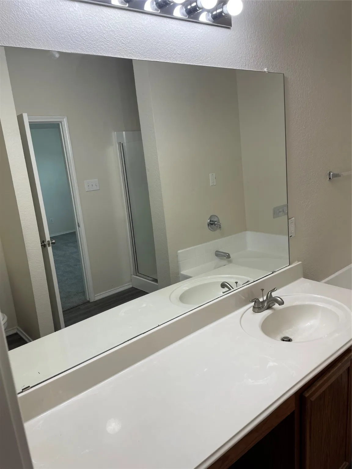 Bathroom featuring vanity and a tub to relax in