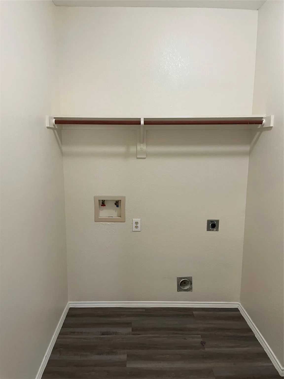 Laundry area with washer hookup, electric dryer hookup, and dark hardwood / wood-style floors