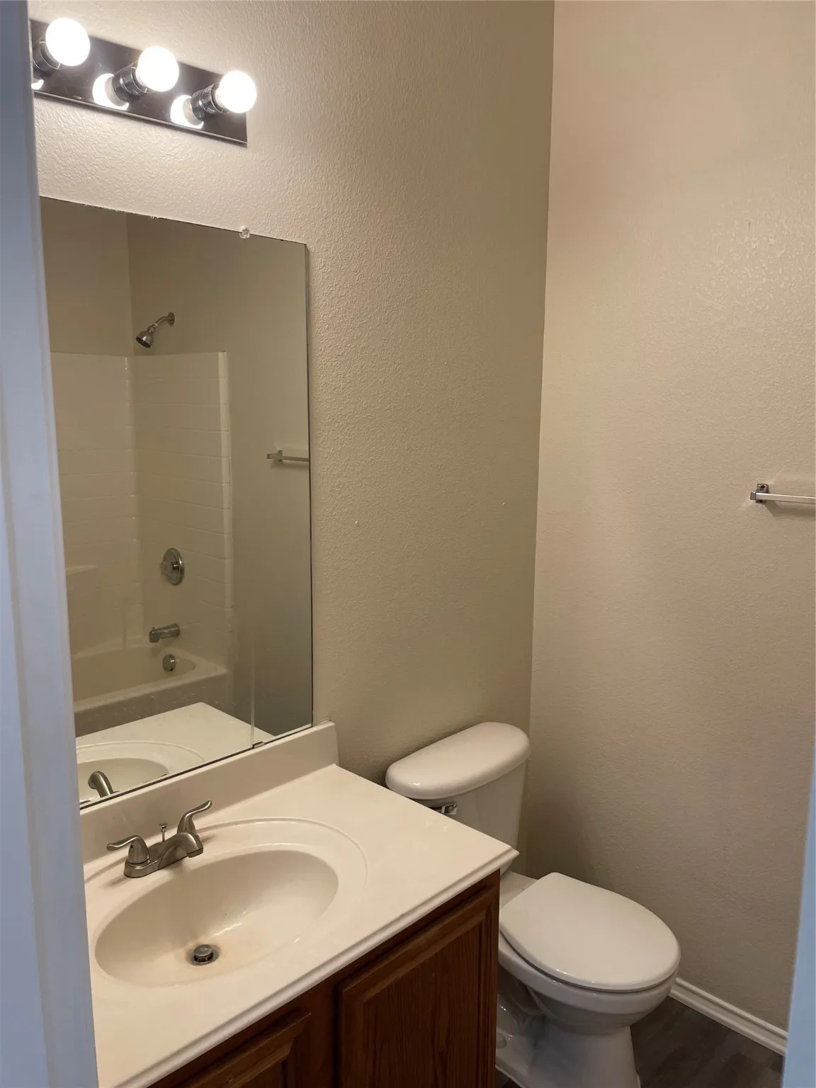 Full bathroom featuring shower / bath combination, vanity, and toilet
