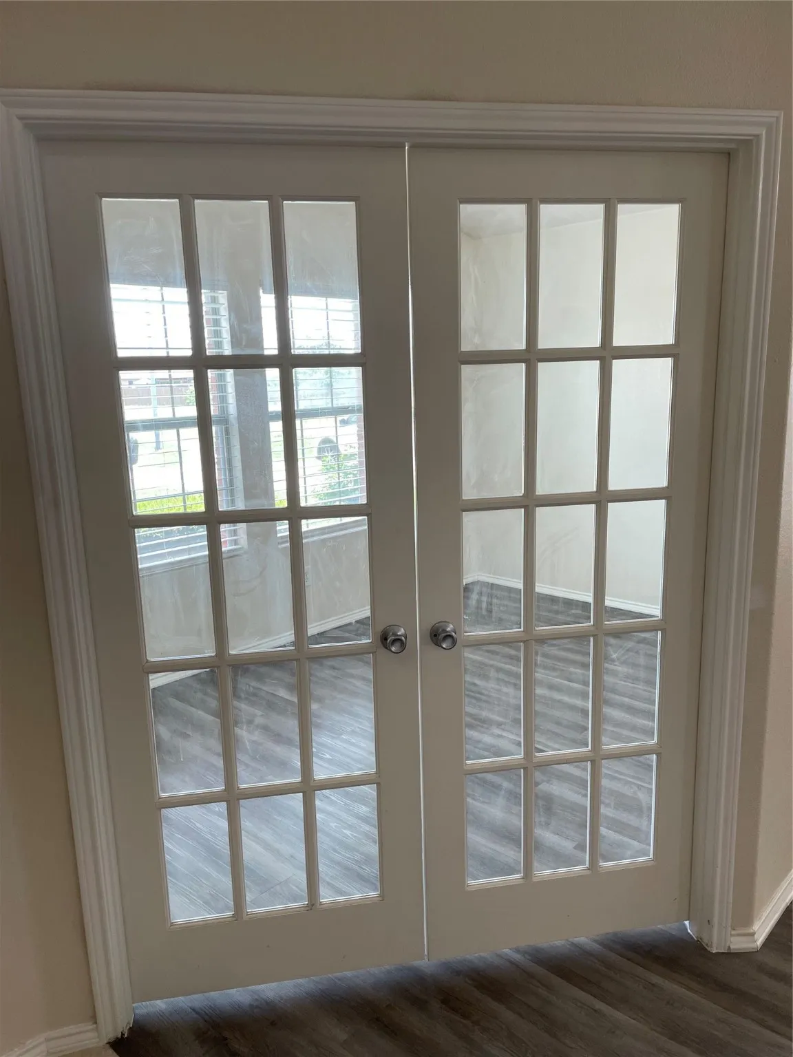 Doorway featuring dark wood-type flooring and french doors
