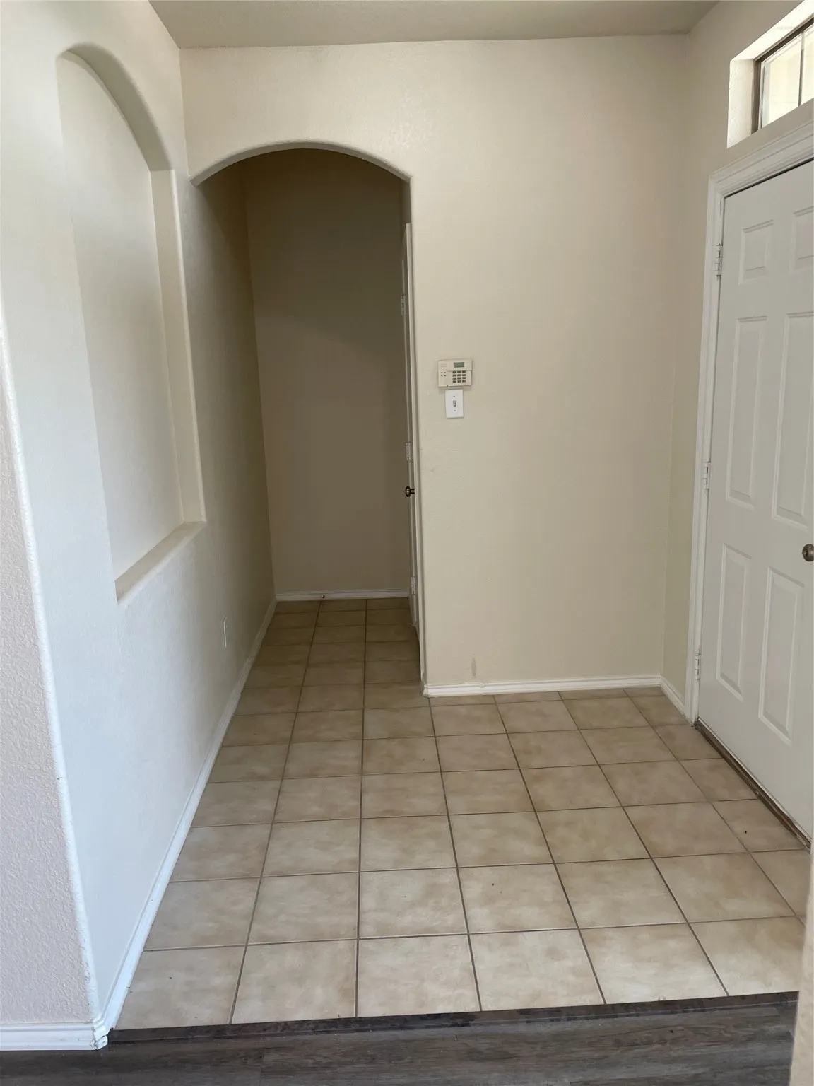 Hallway featuring light tile patterned flooring