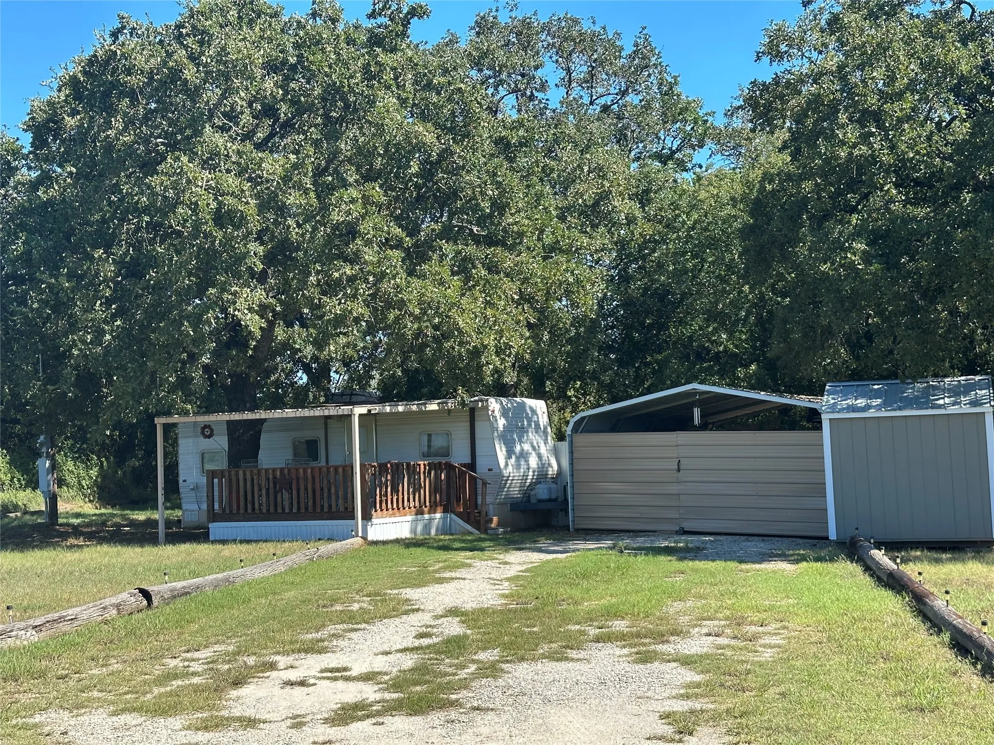 View of front of property with a storage shed, a porch, and a front yard