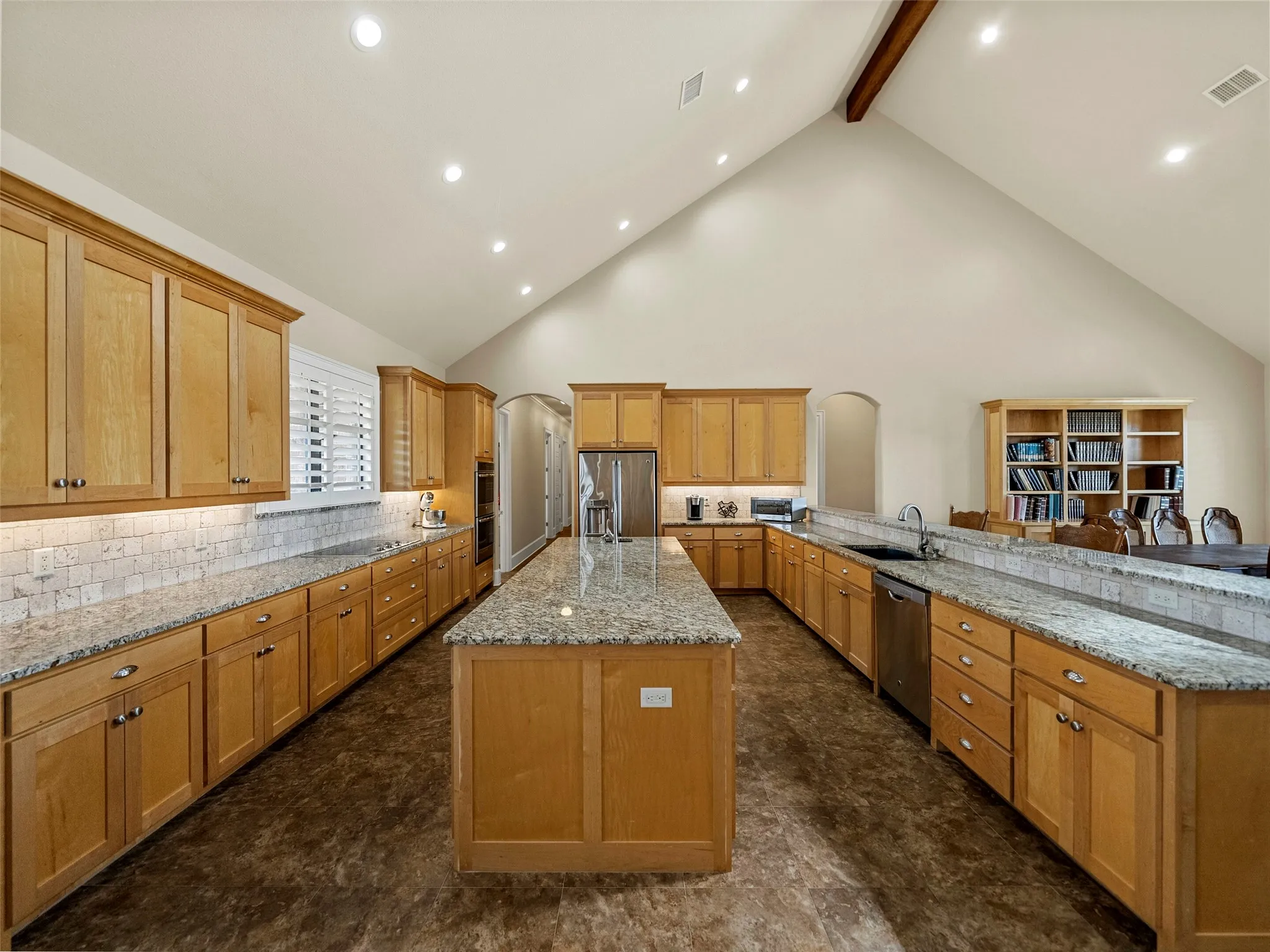 KITCHEN...Tumbled Marble Backsplash, Under Cabinet Lights, Vaulted Ceiling