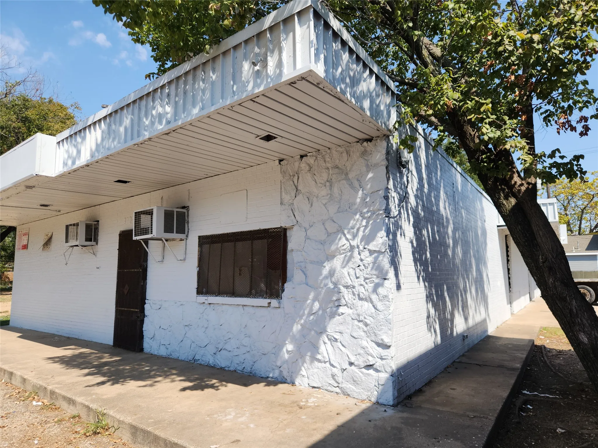 View of side of property with a wall mounted air conditioner