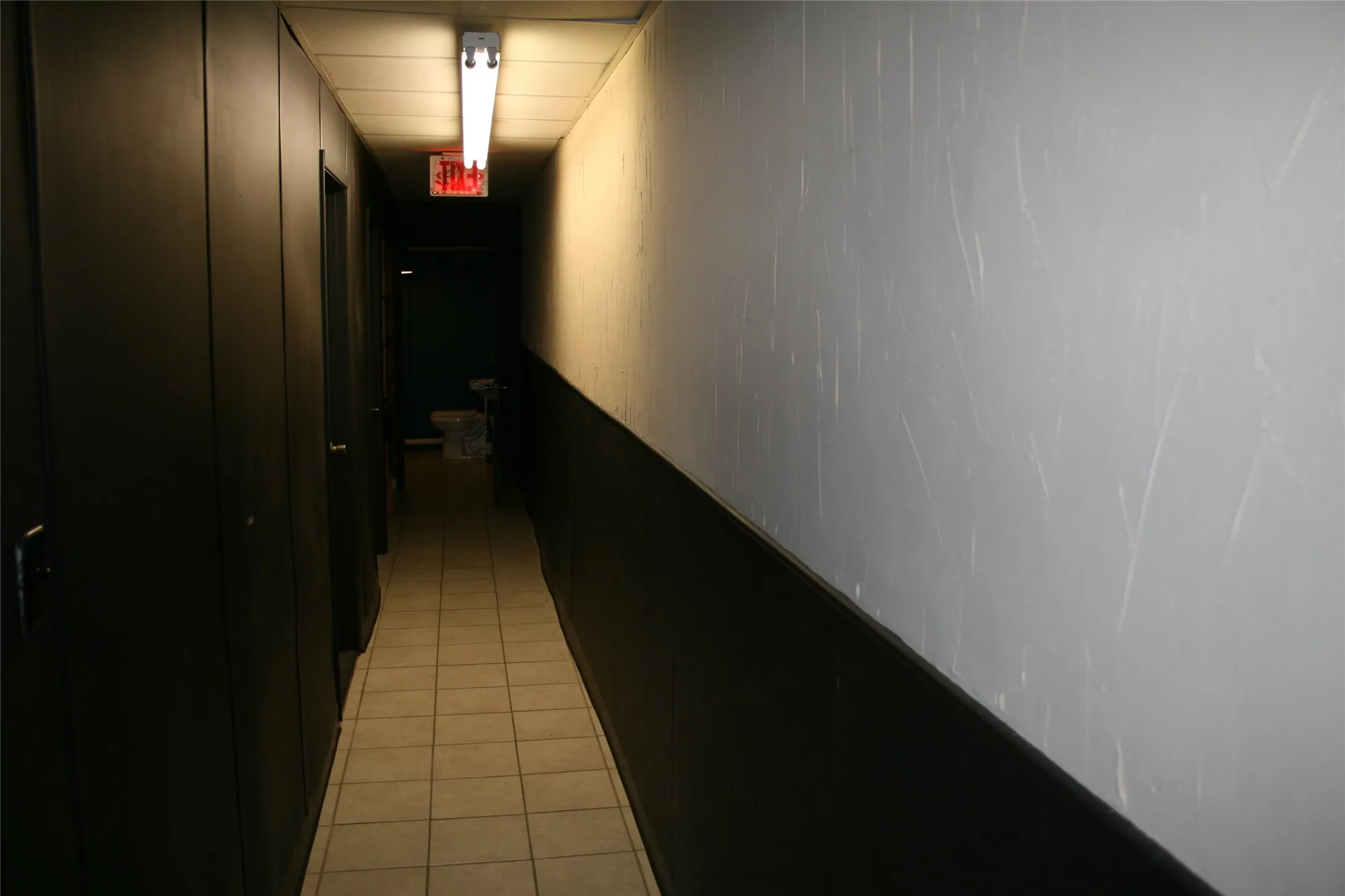 Hall featuring light tile patterned floors