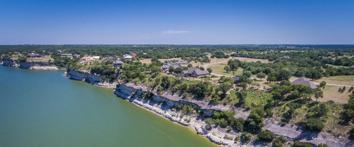 Birds eye view of property with a water view