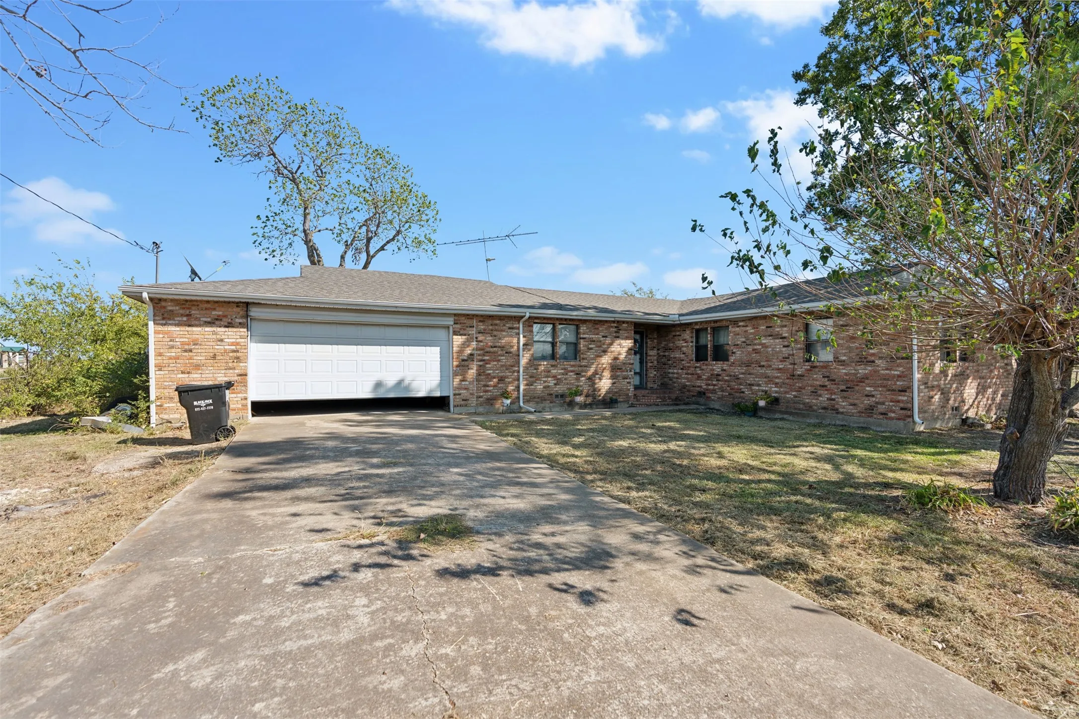 Ranch-style home with a front lawn and a garage