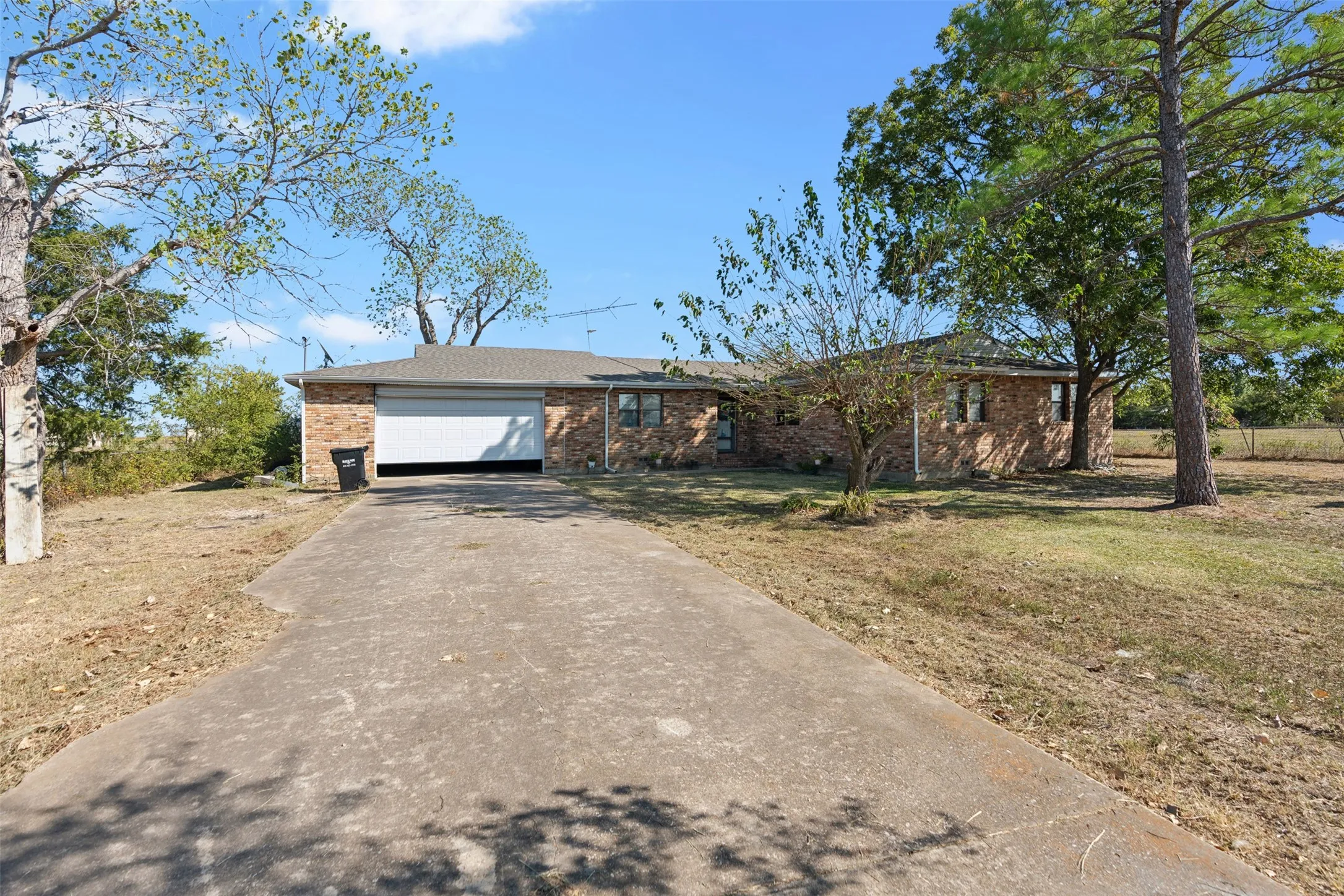 Ranch-style home featuring a front yard and a garage
