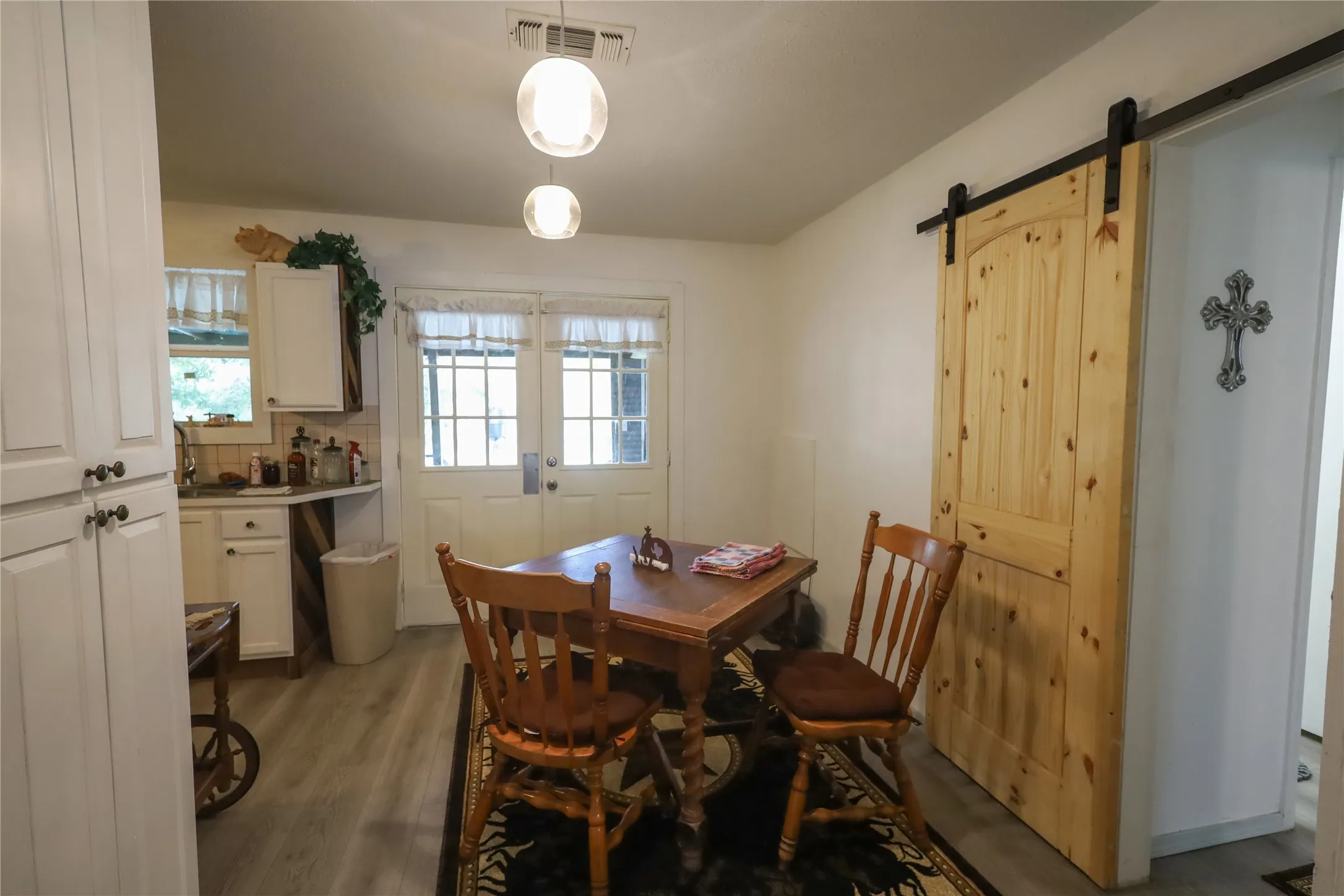 Dining room featuring a barn door, light hardwood / wood-style floors, and plenty of natural light