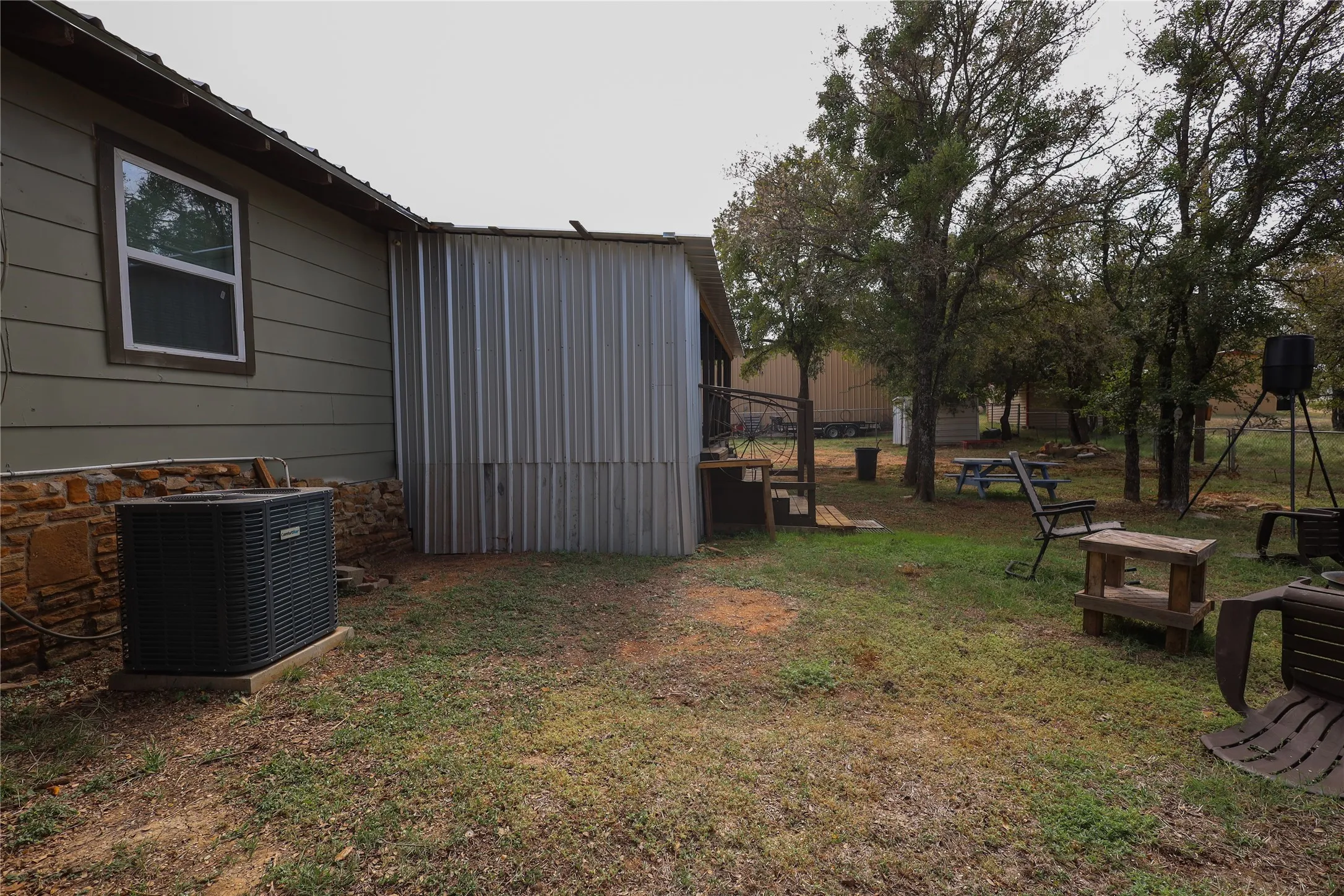 View of yard with an outdoor structure and central air condition unit
