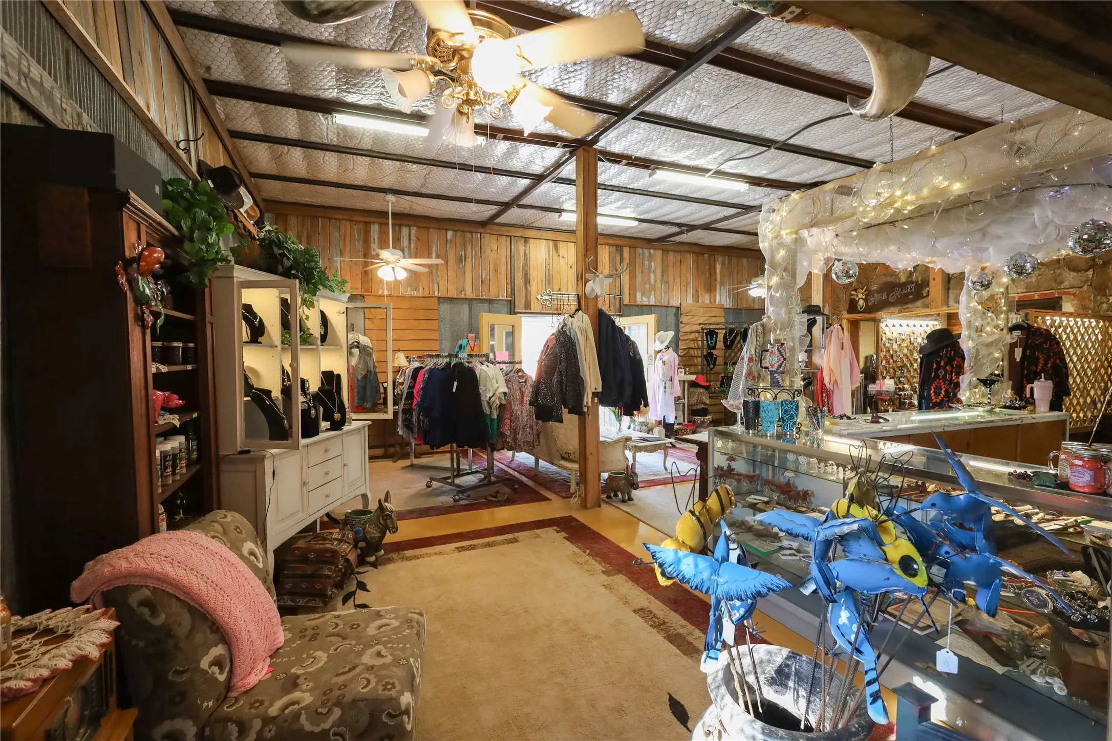Miscellaneous room with wood walls and ceiling fan