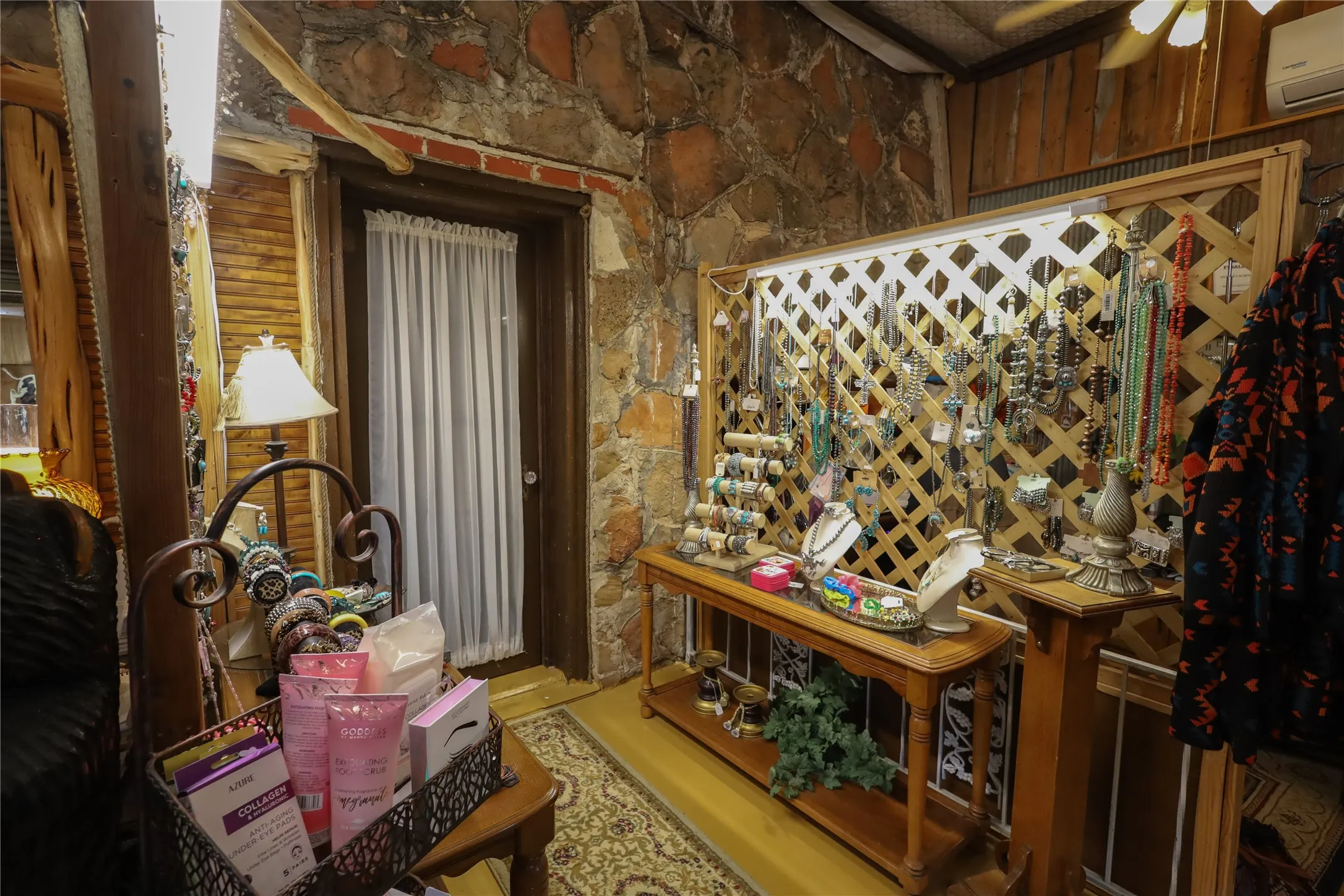 Wine cellar featuring a wall mounted air conditioner and ceiling fan