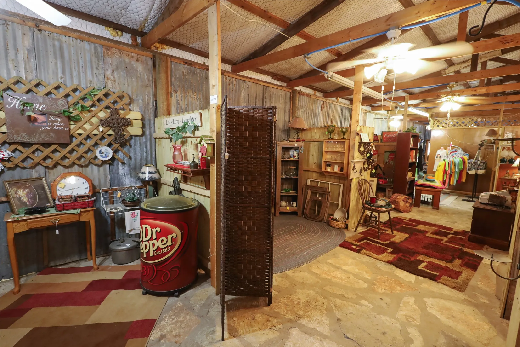 Miscellaneous room with concrete floors, lofted ceiling, and ceiling fan