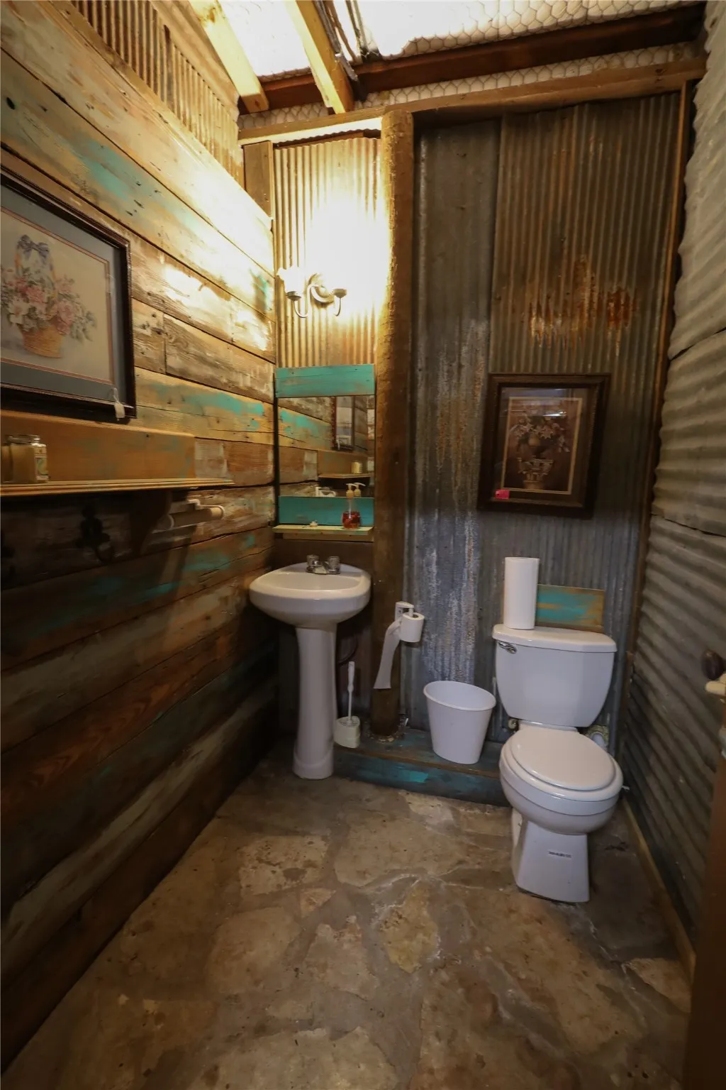 Bathroom featuring wooden walls and toilet