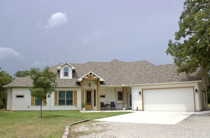 View of front facade with a front yard and a garage