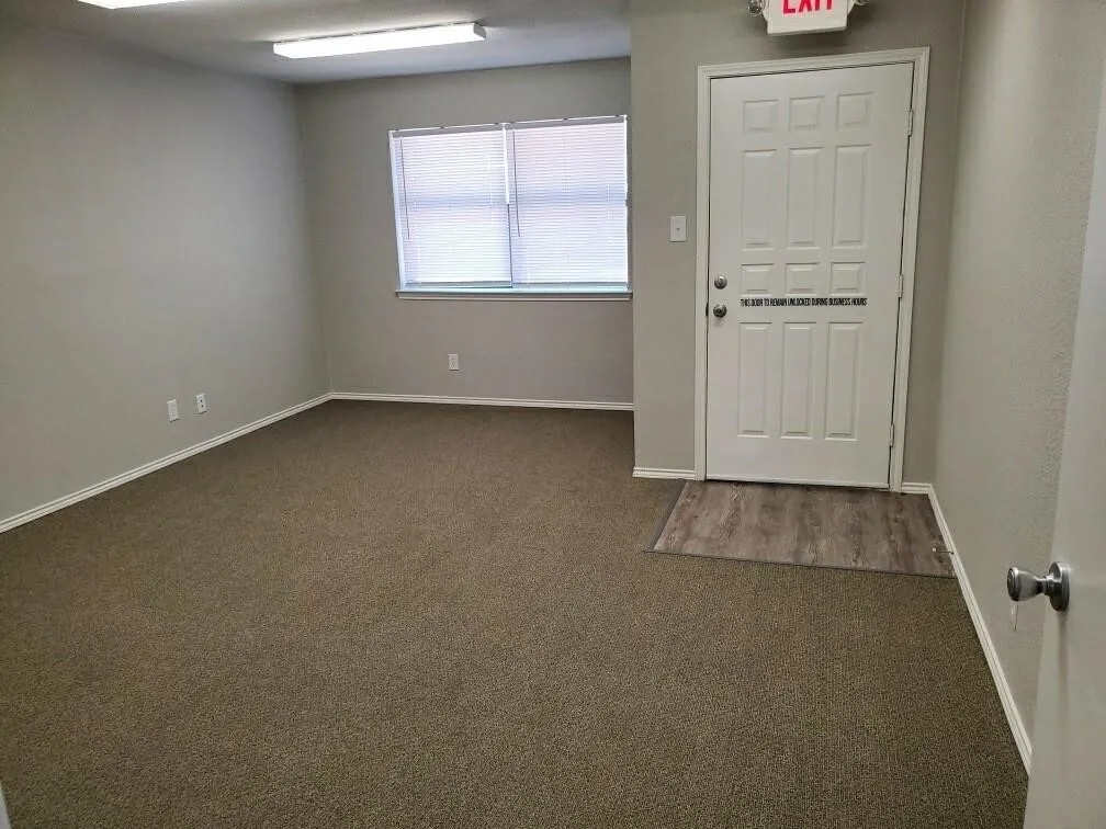Foyer entrance with dark carpet