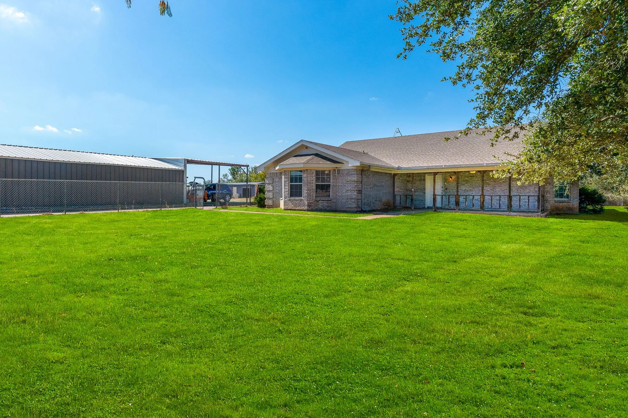Back of property featuring a yard