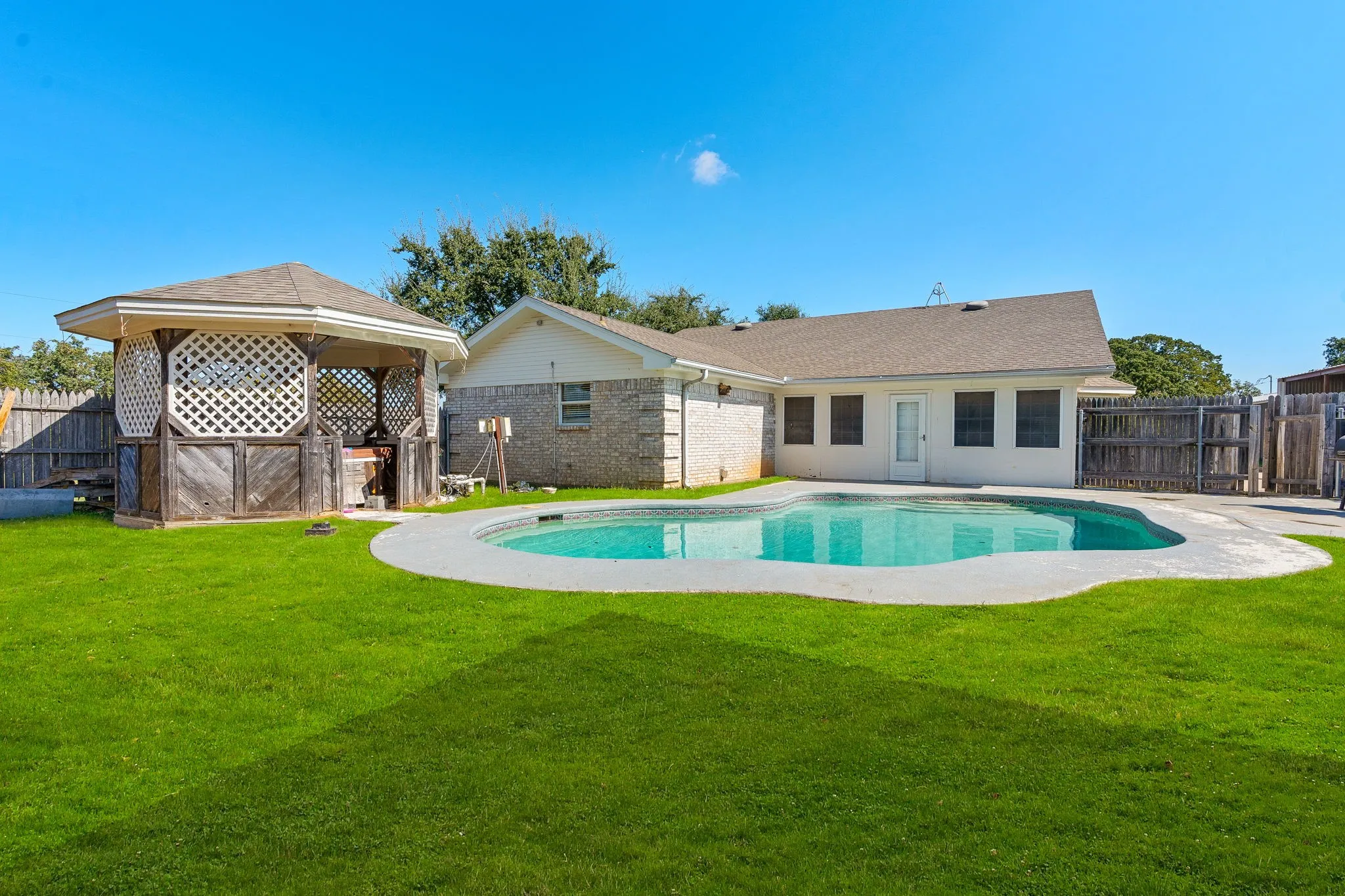 View of swimming pool featuring a yard
