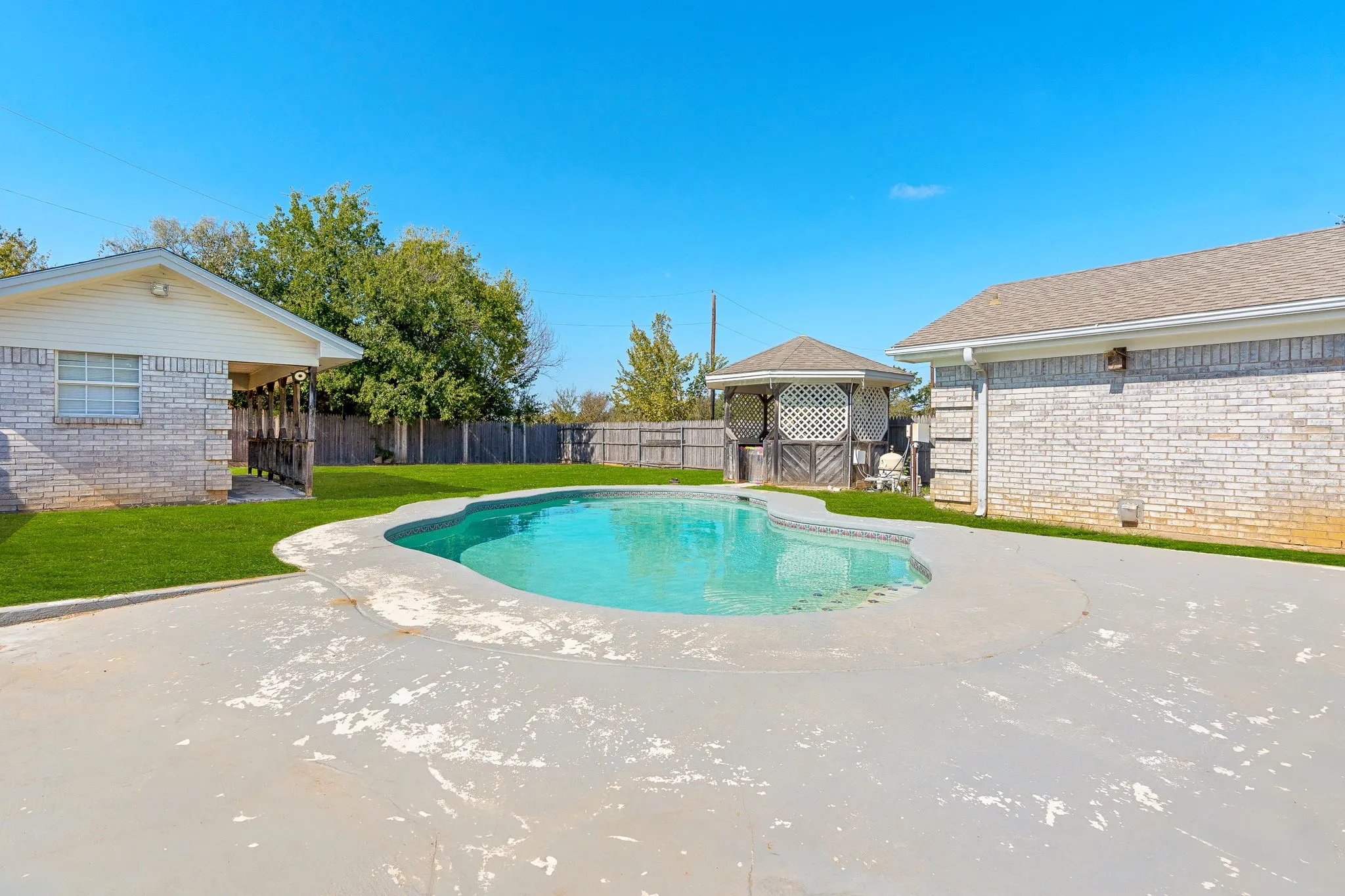 View of pool featuring a patio area and a lawn