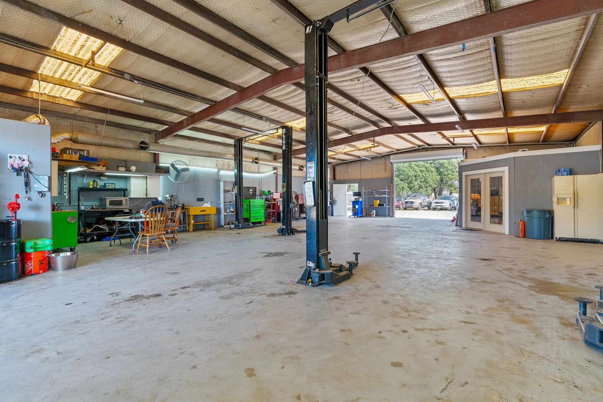 Garage with french doors and white fridge with ice dispenser