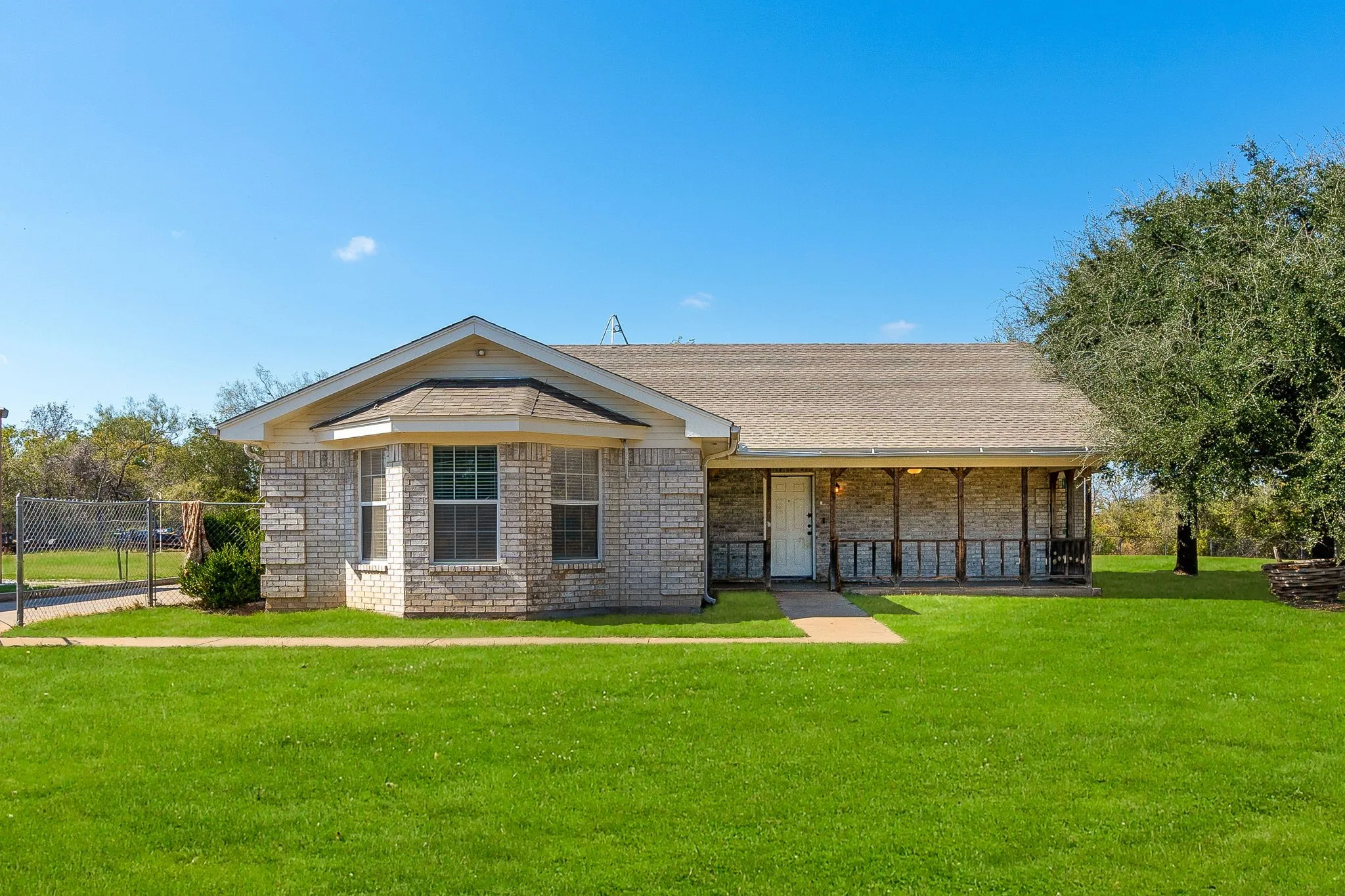 Single story home featuring a front lawn