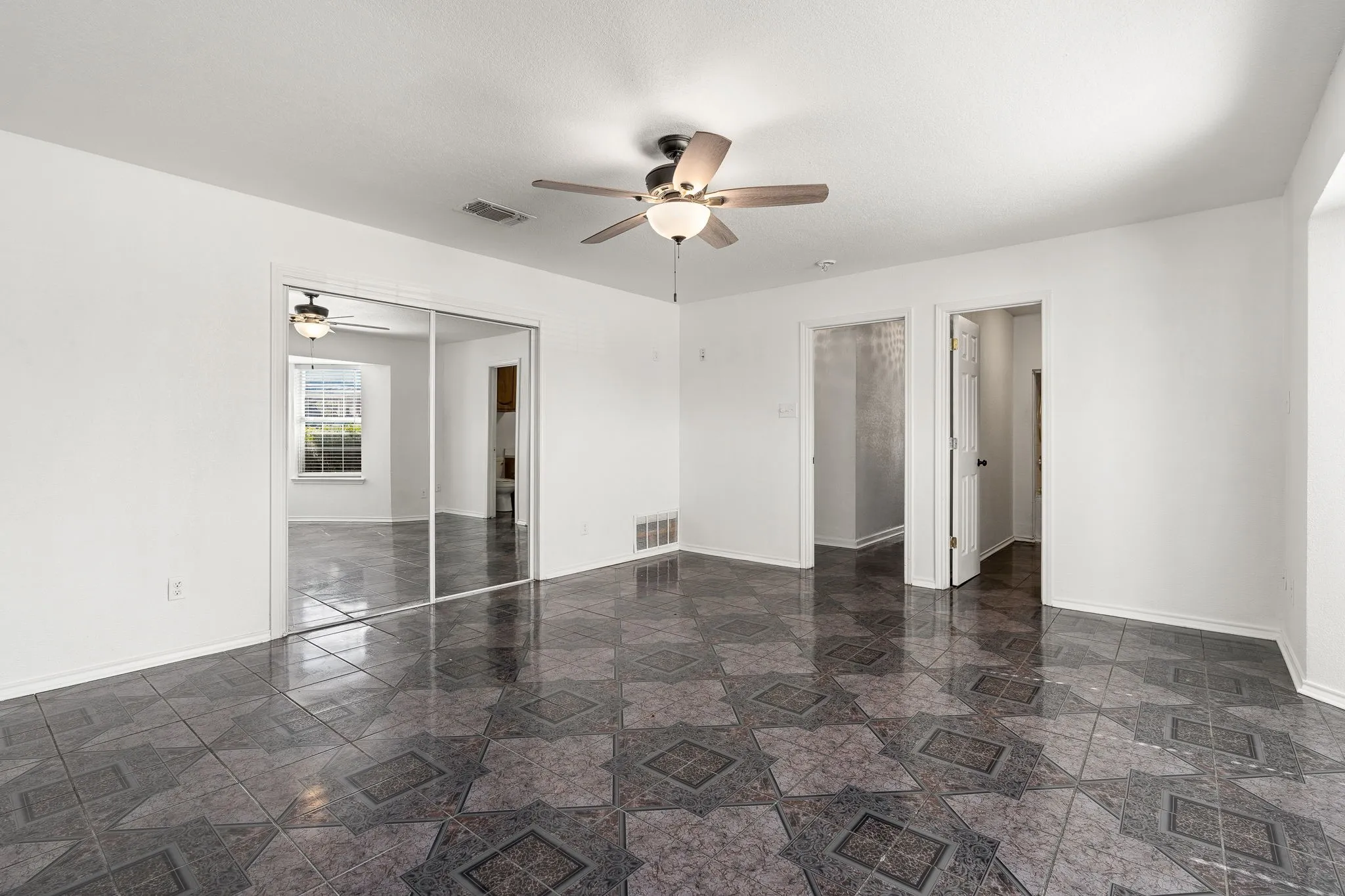 Unfurnished bedroom featuring a closet and ceiling fan