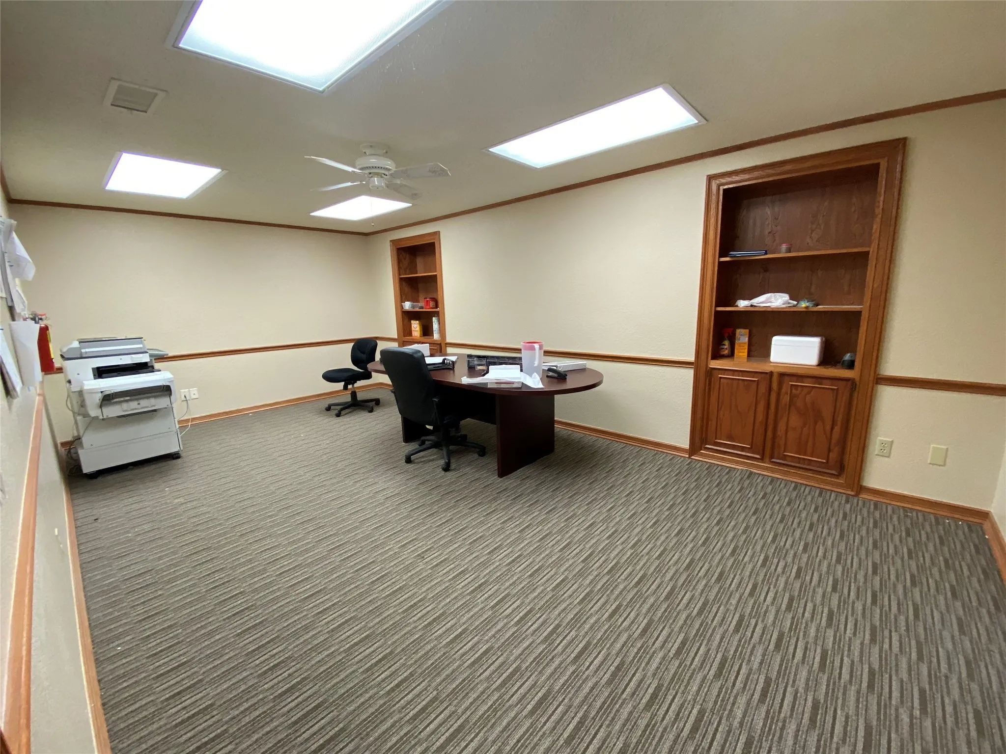 Office featuring dark carpet, ornamental molding, and ceiling fan