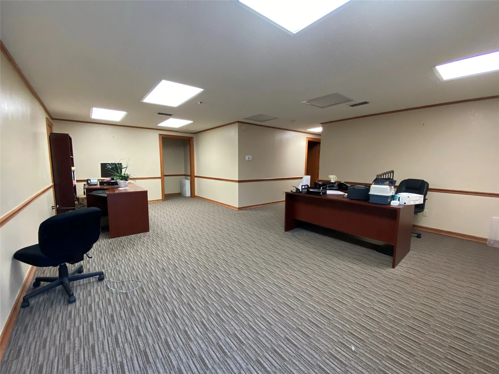 Office space with carpet and crown molding