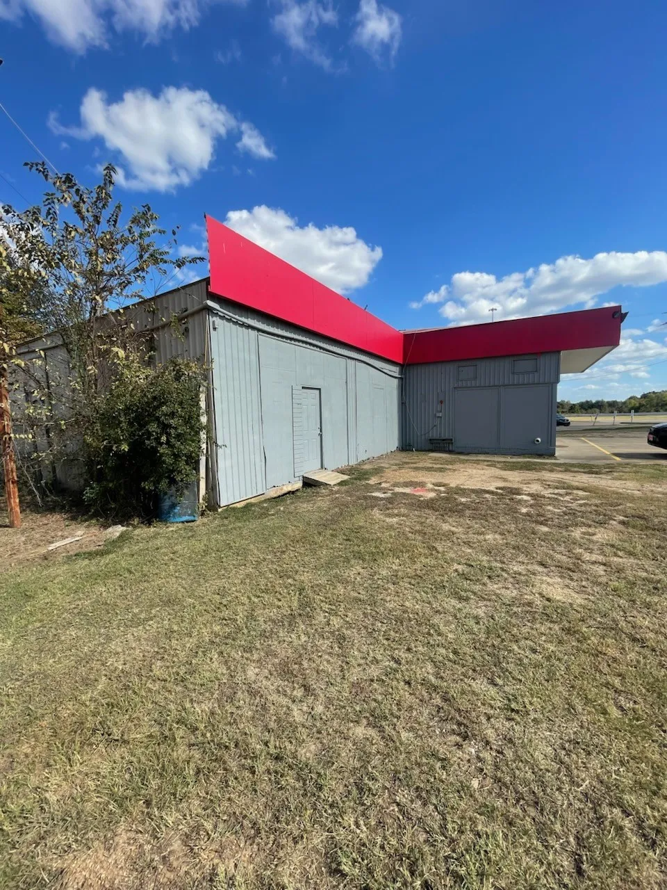 View of outdoor structure with a yard