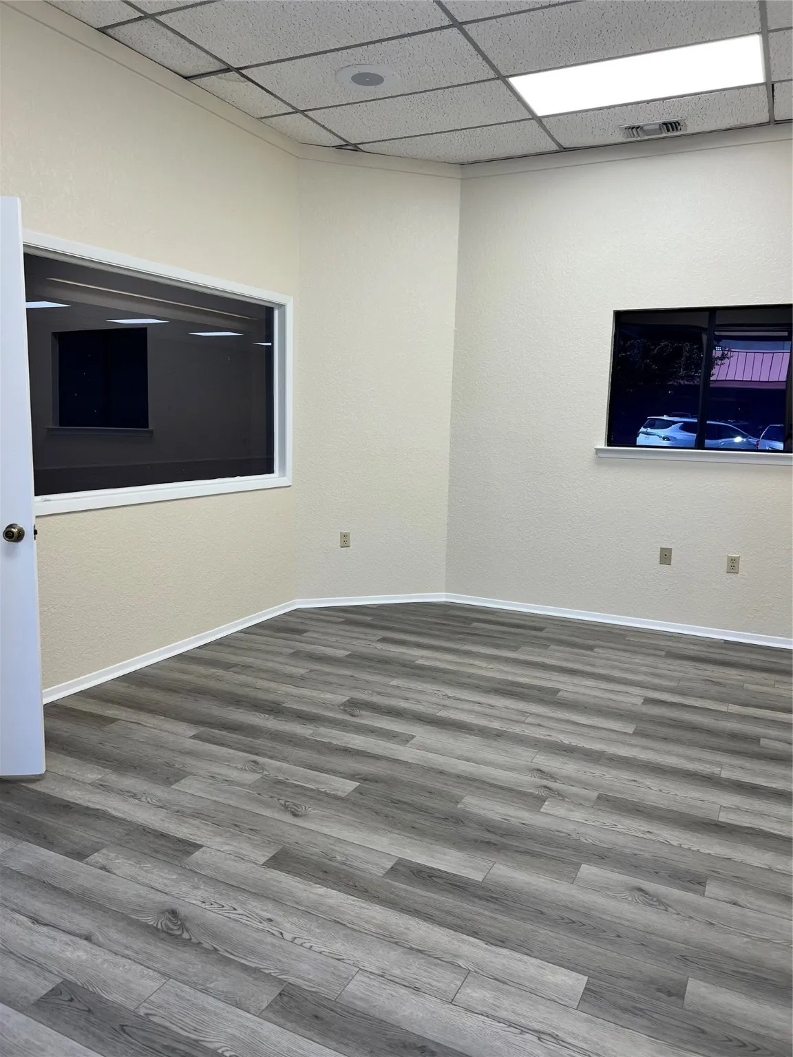 Spare room with hardwood / wood-style floors and a paneled ceiling