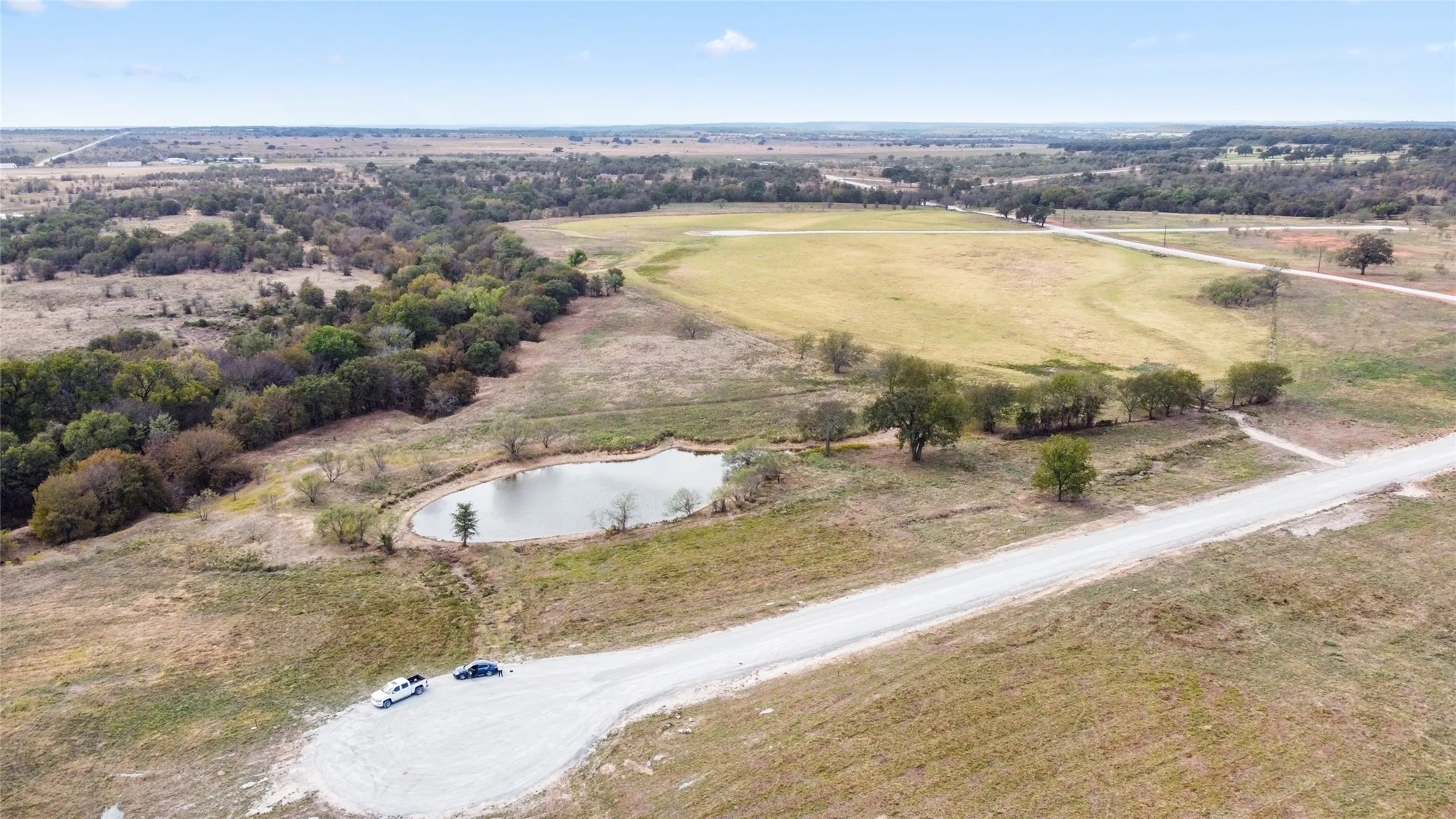 Aerial view featuring a water view and a rural view