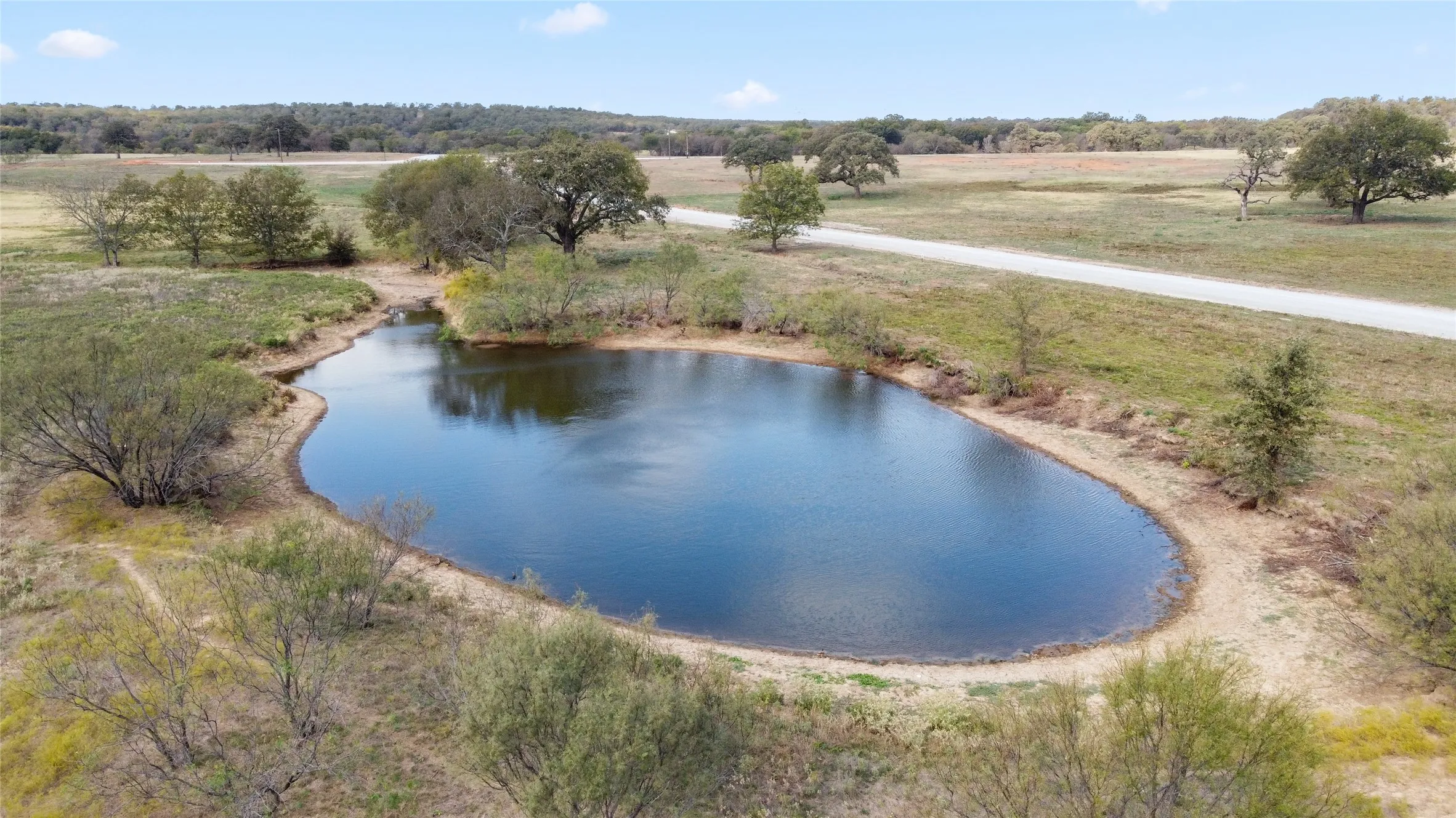 Drone / aerial view with a water view and a rural view