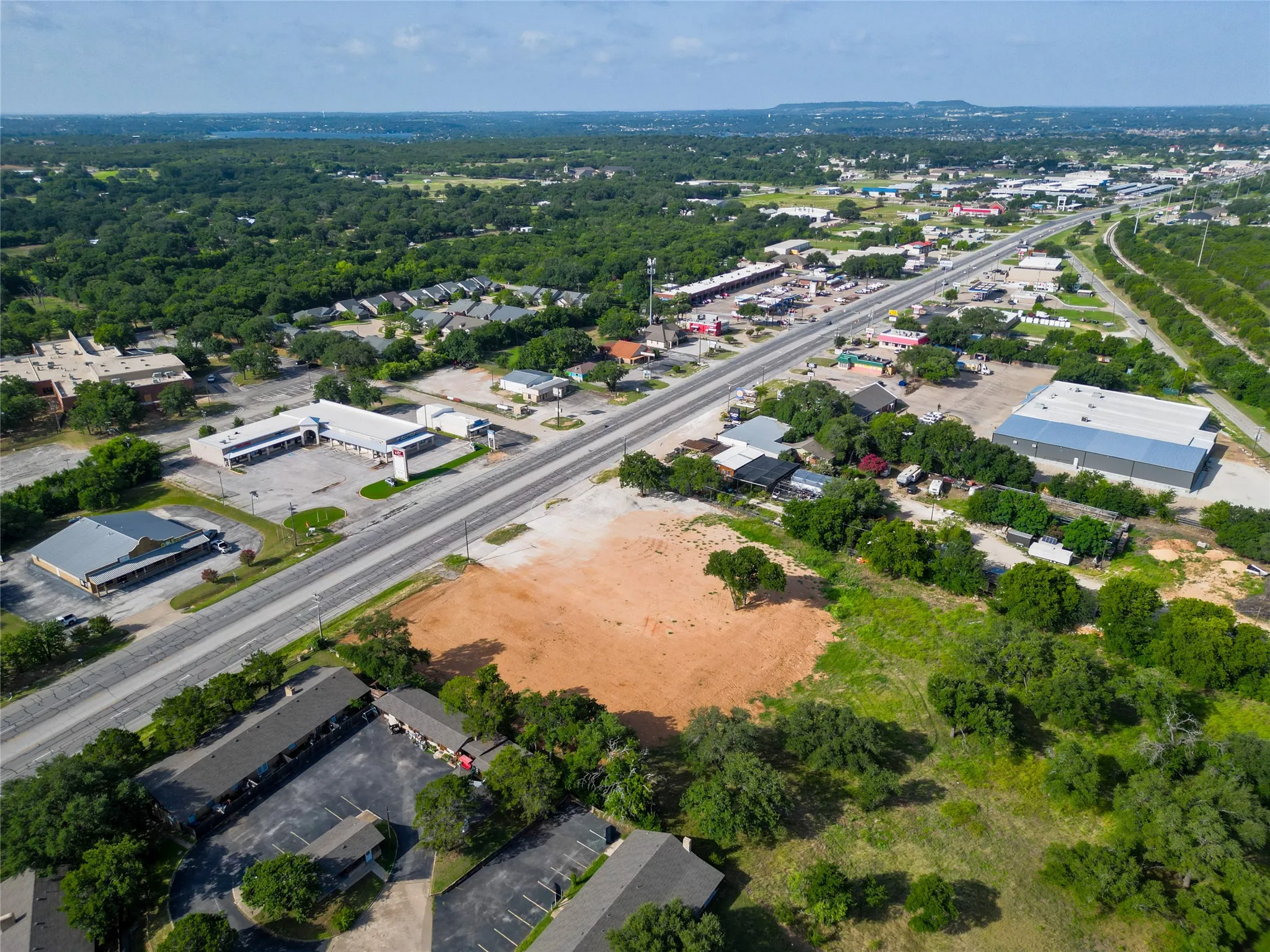 Expansive undeveloped lot featuring clear land for development and surrounding mature trees