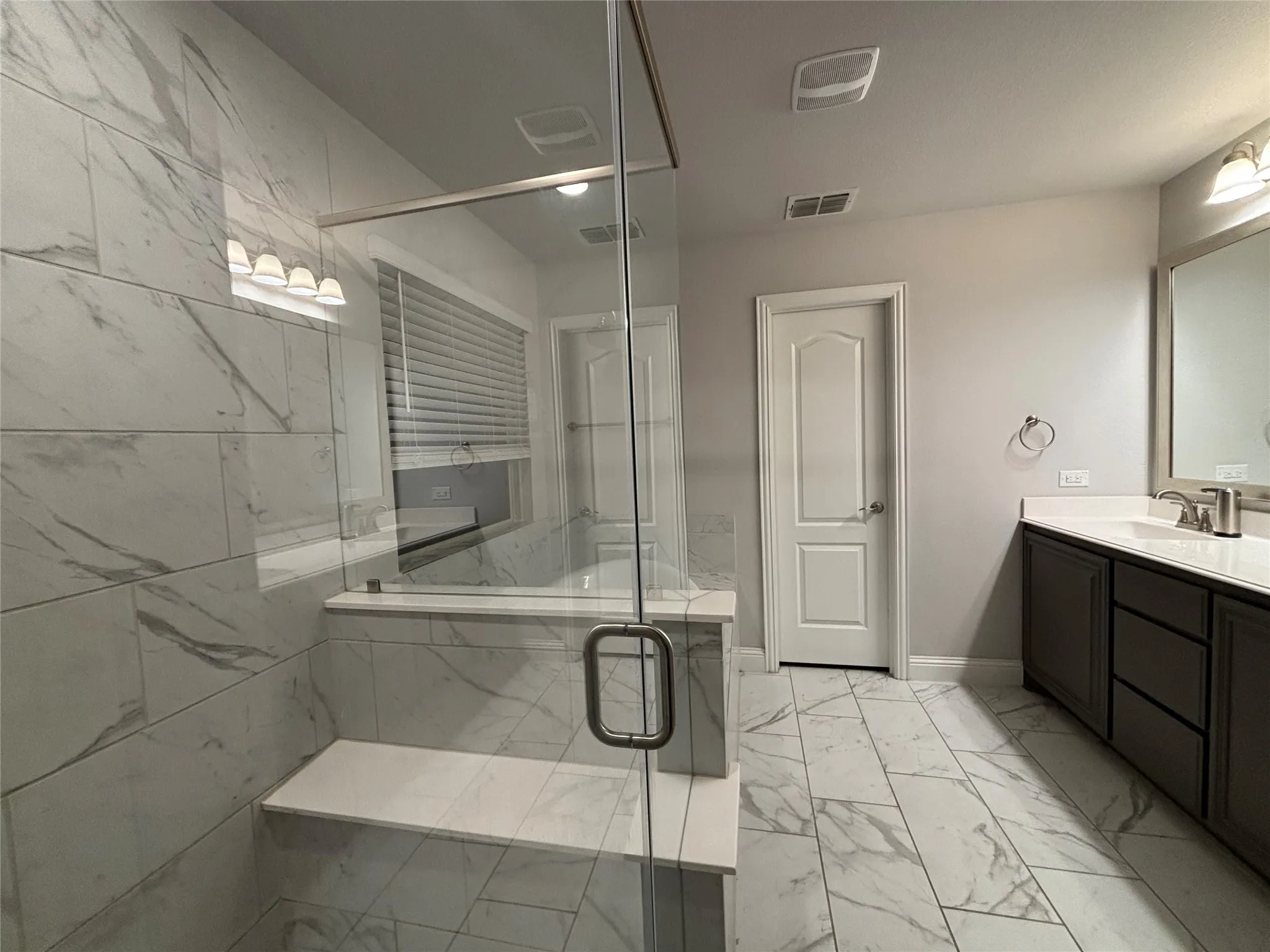 Bathroom featuring vanity and walk in shower