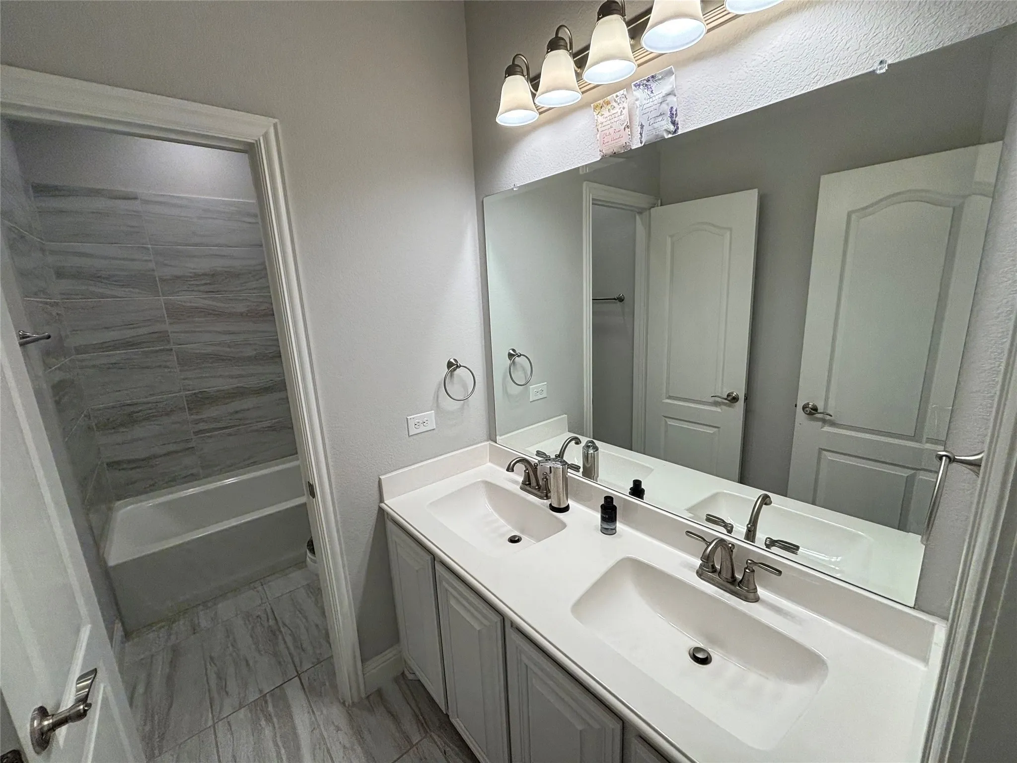 Bathroom with vanity and tub / shower combination