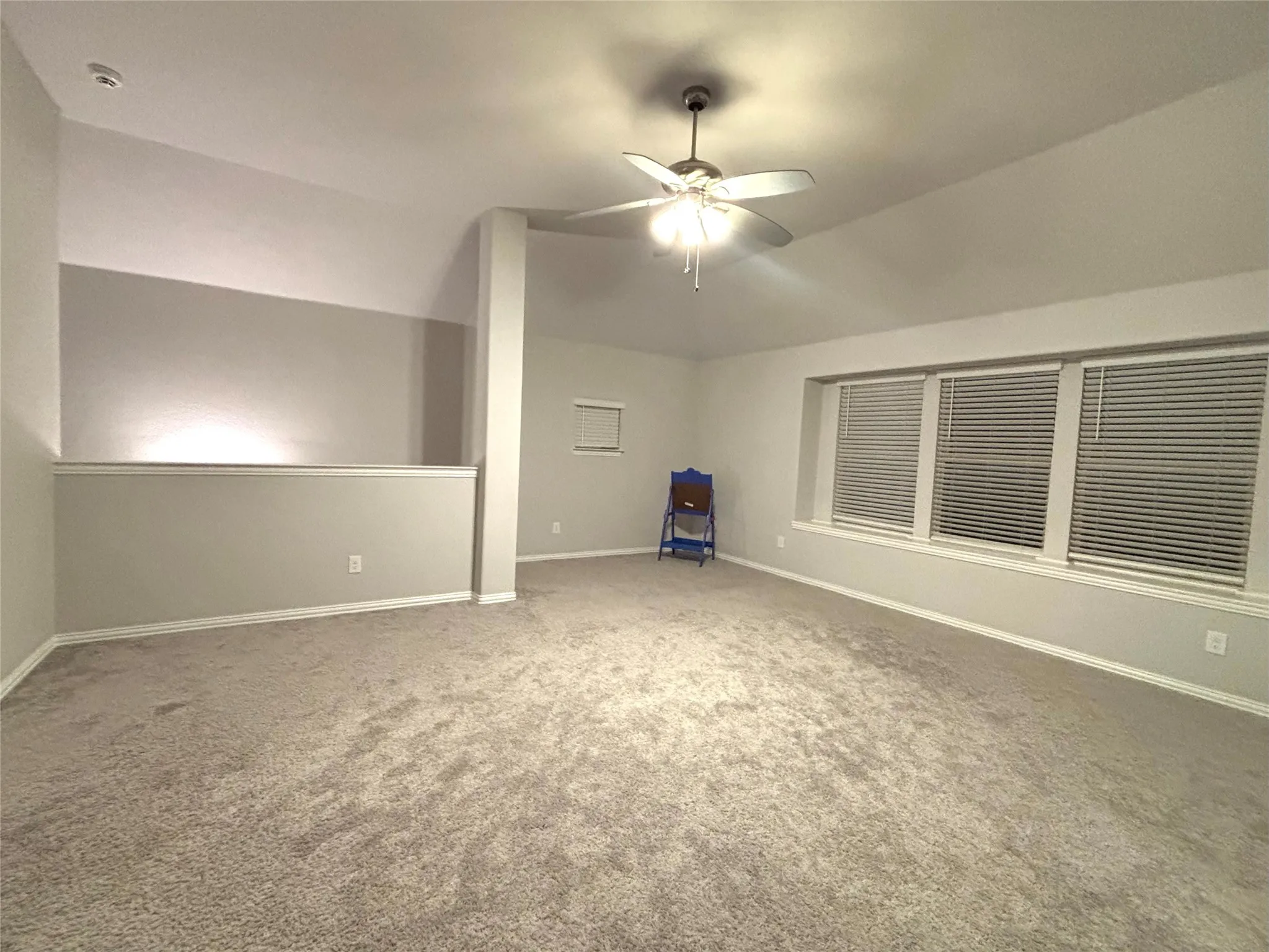 Bonus room with carpet flooring, ceiling fan, and lofted ceiling
