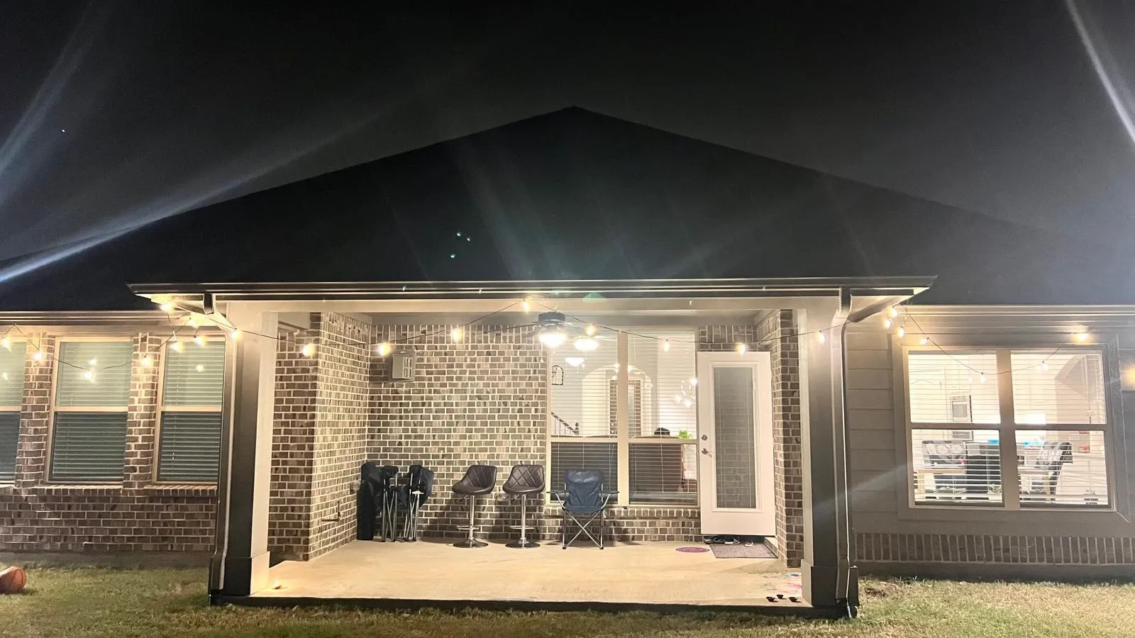 Back house at twilight featuring a patio area