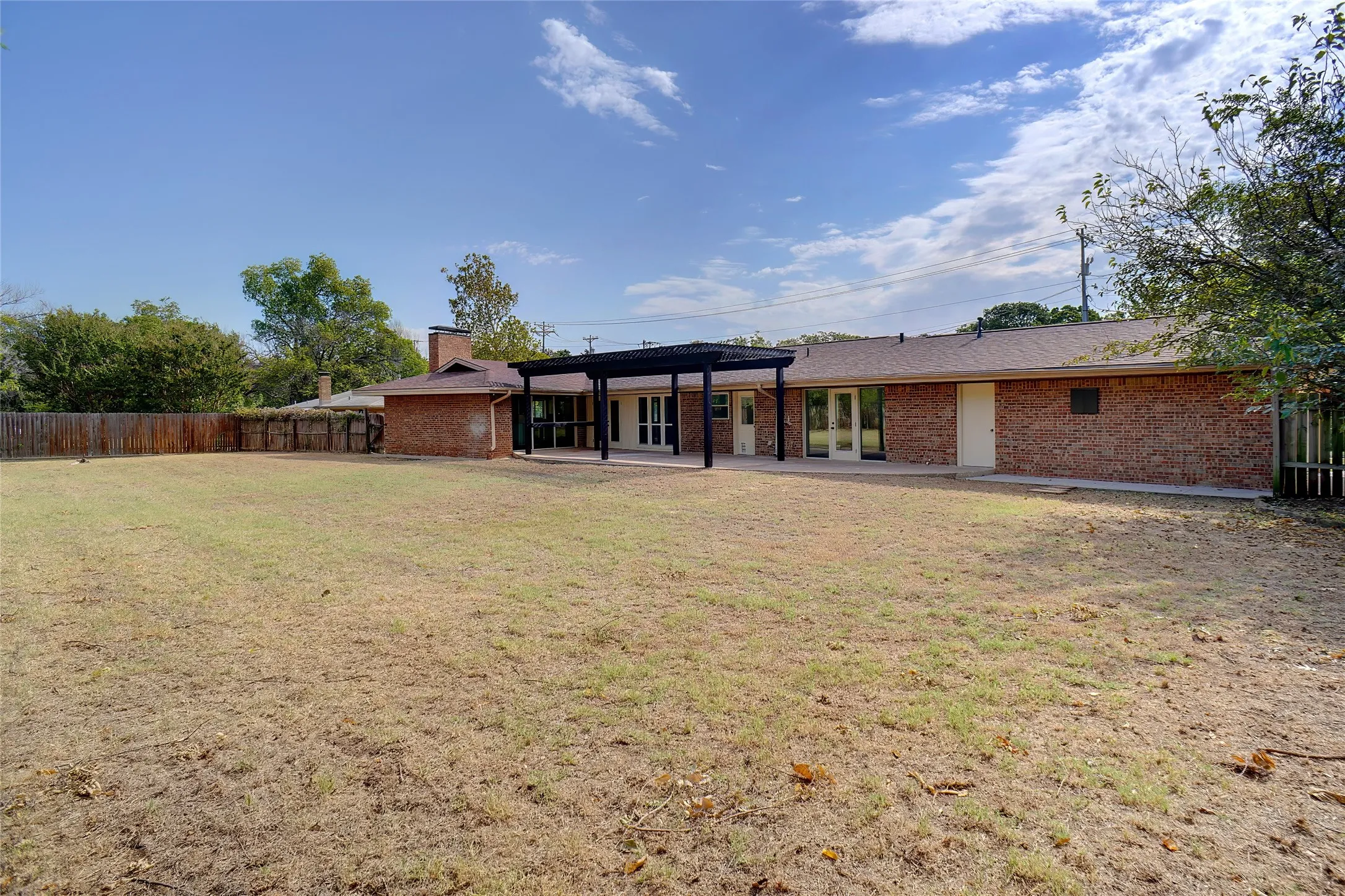 Back of property with a patio and a yard