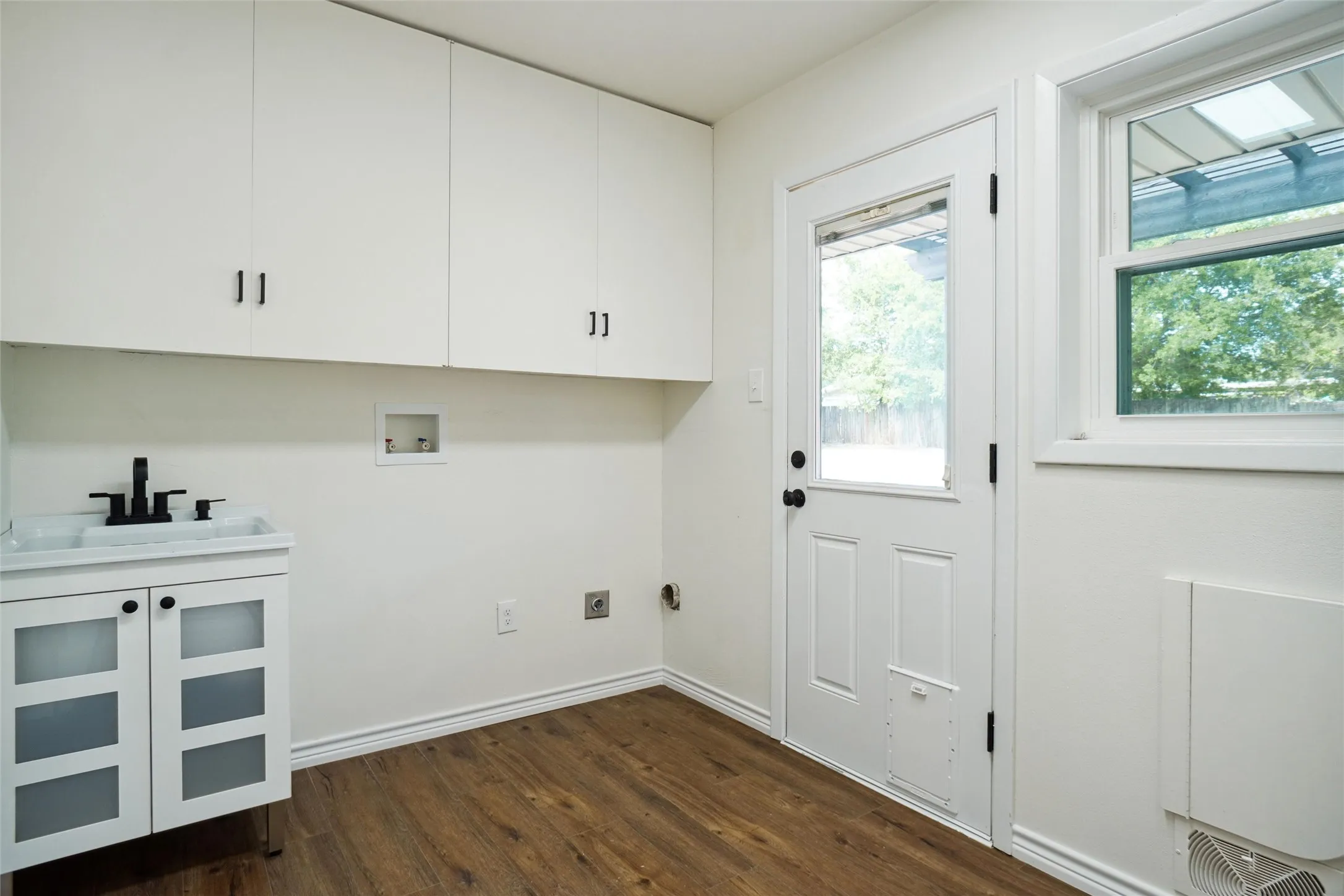 Laundry room with washer hookup, dark hardwood / wood-style floors, cabinets, sink, and electric dryer hookup