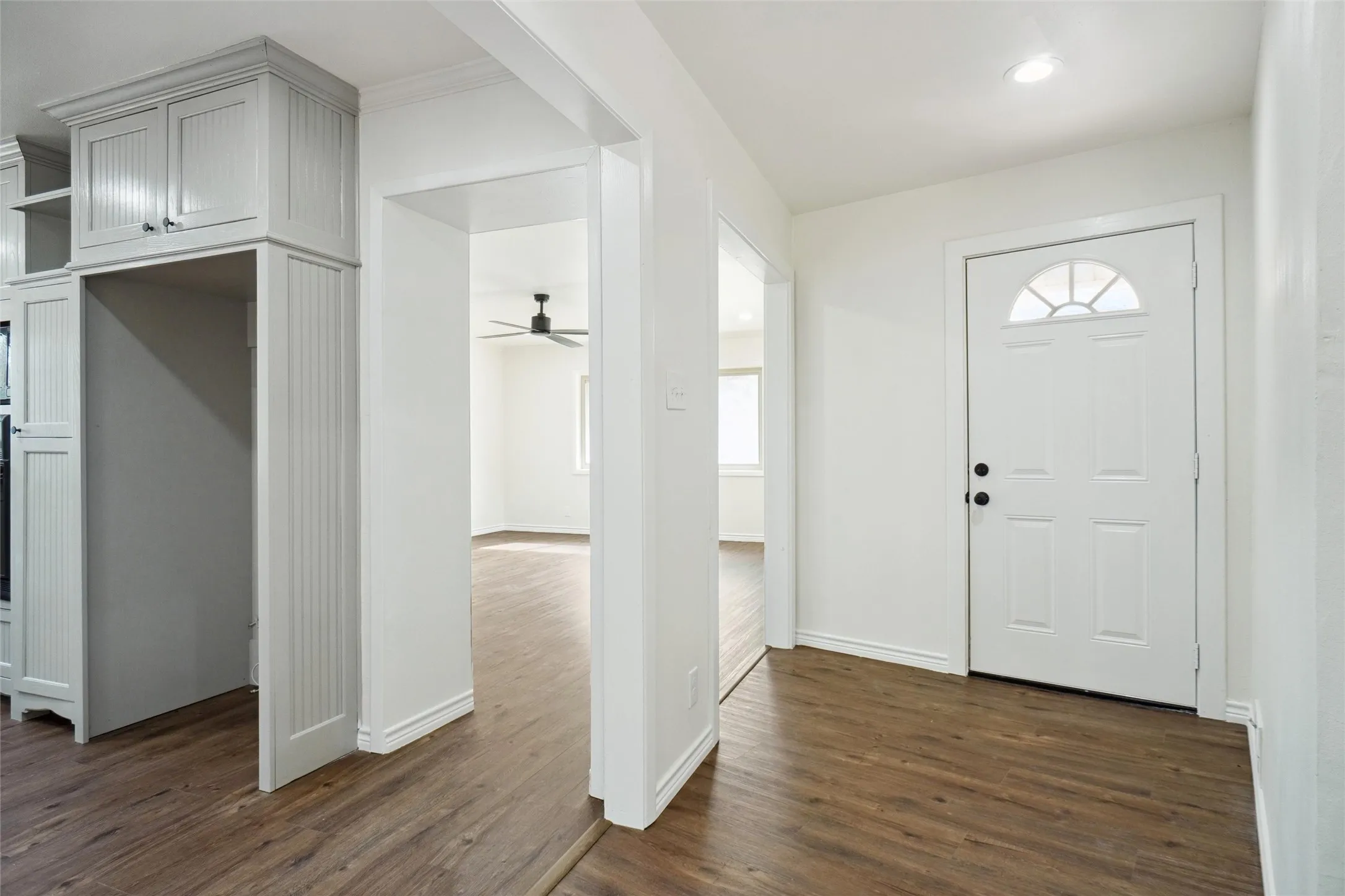 Entryway with ceiling fan and dark hardwood / wood-style floors