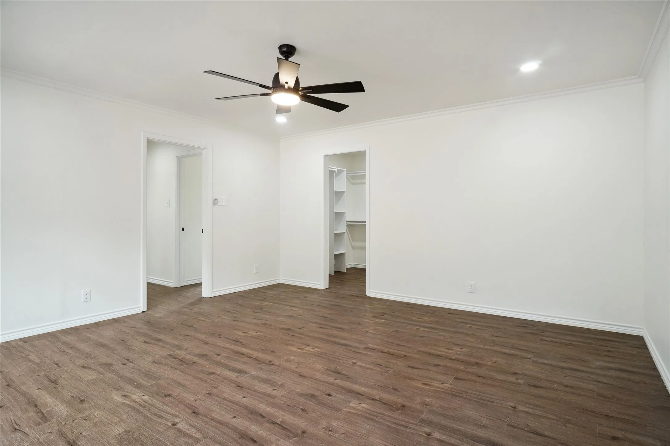 Unfurnished room with dark hardwood / wood-style floors, crown molding, and ceiling fan