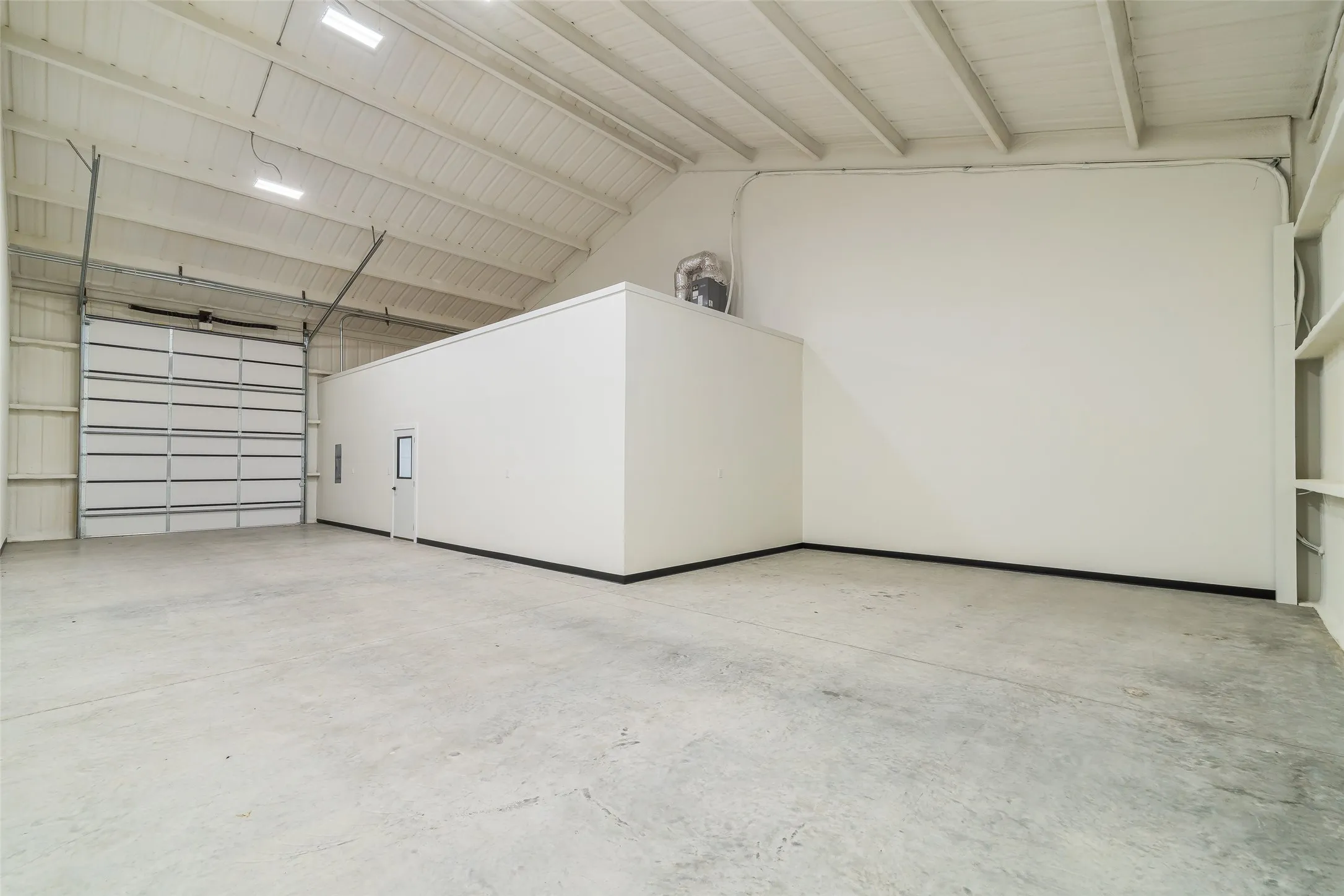 Warehouse space of premium floorplan. All spaces include 20 ft ceilings and 14 foot bay doors with a garage door opener option!