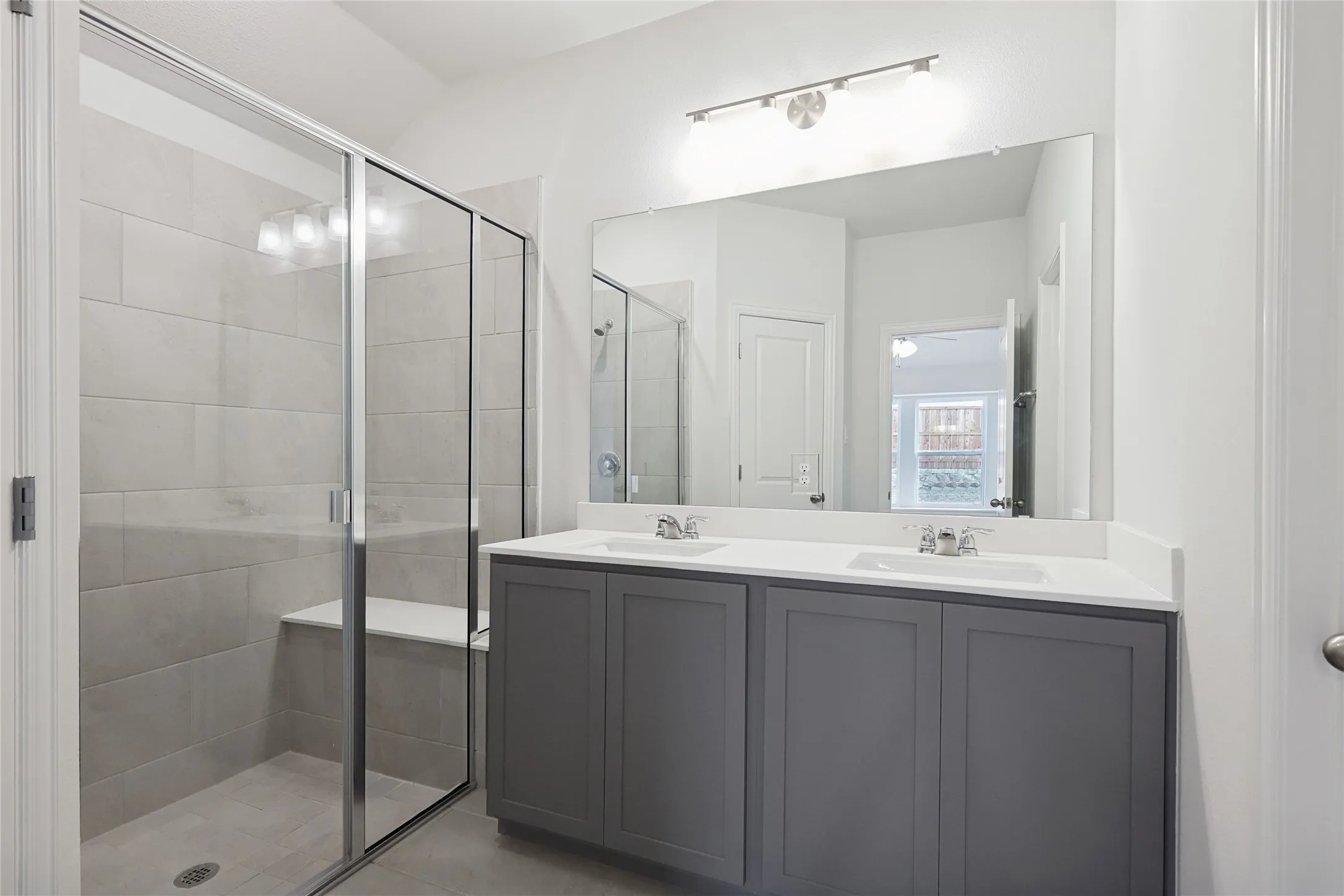 Bathroom featuring vanity and a shower with shower door