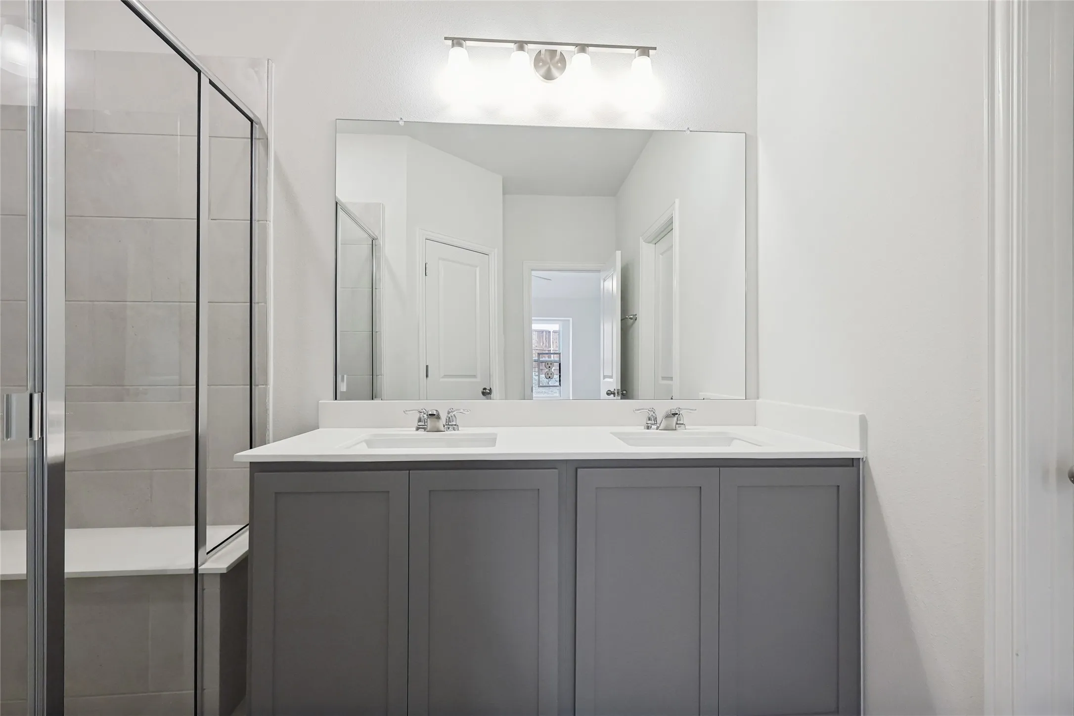 Bathroom with a shower with door and vanity